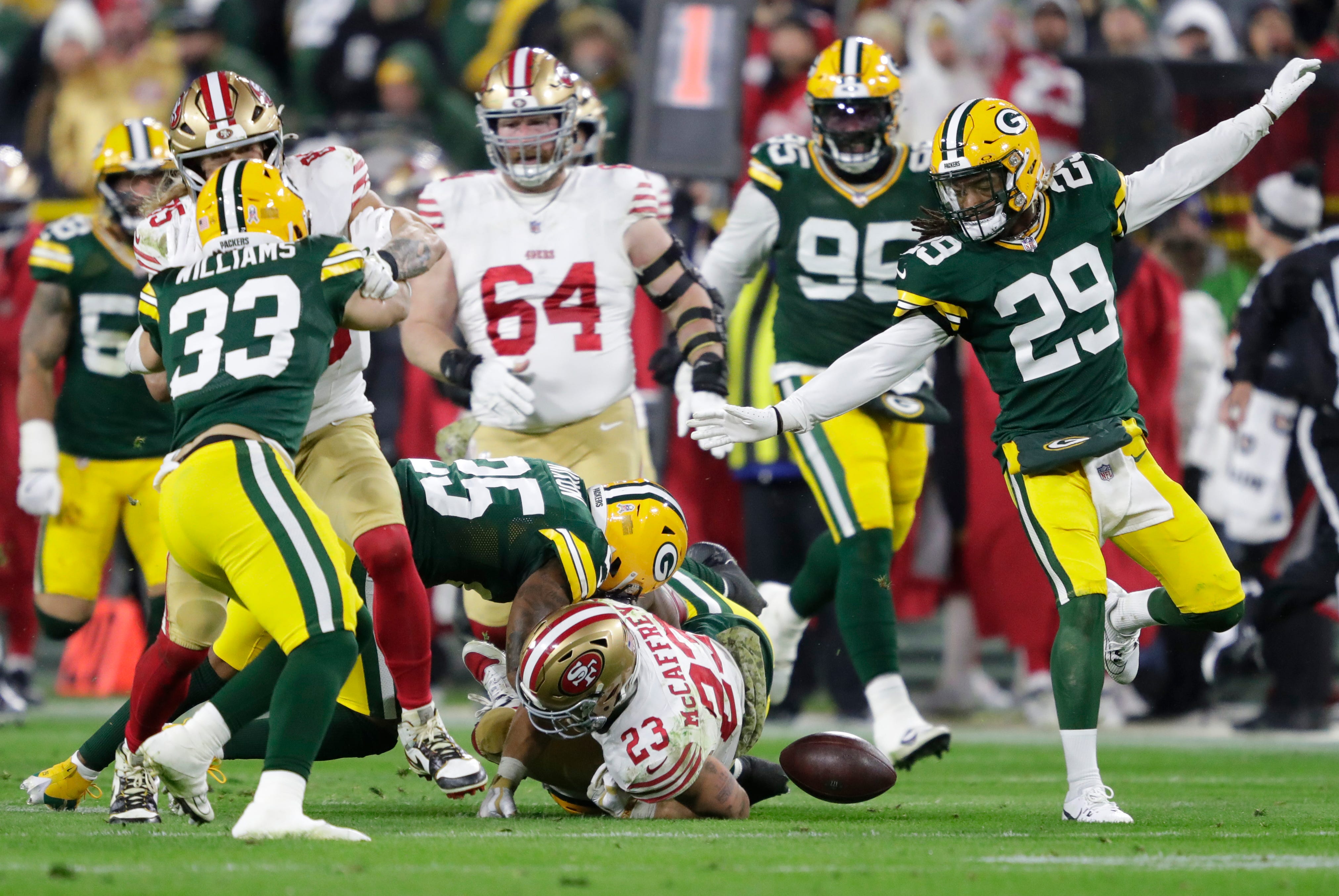 San Francisco 49ers running back Christian McCaffrey (23) fumbles the ball against the Green Bay Packers during their football game Sunday, November 24, 2024, at Lambeau Field in Green Bay, Wisconsin. Packers defensive end Karl Brooks (94) recovered the fumble.