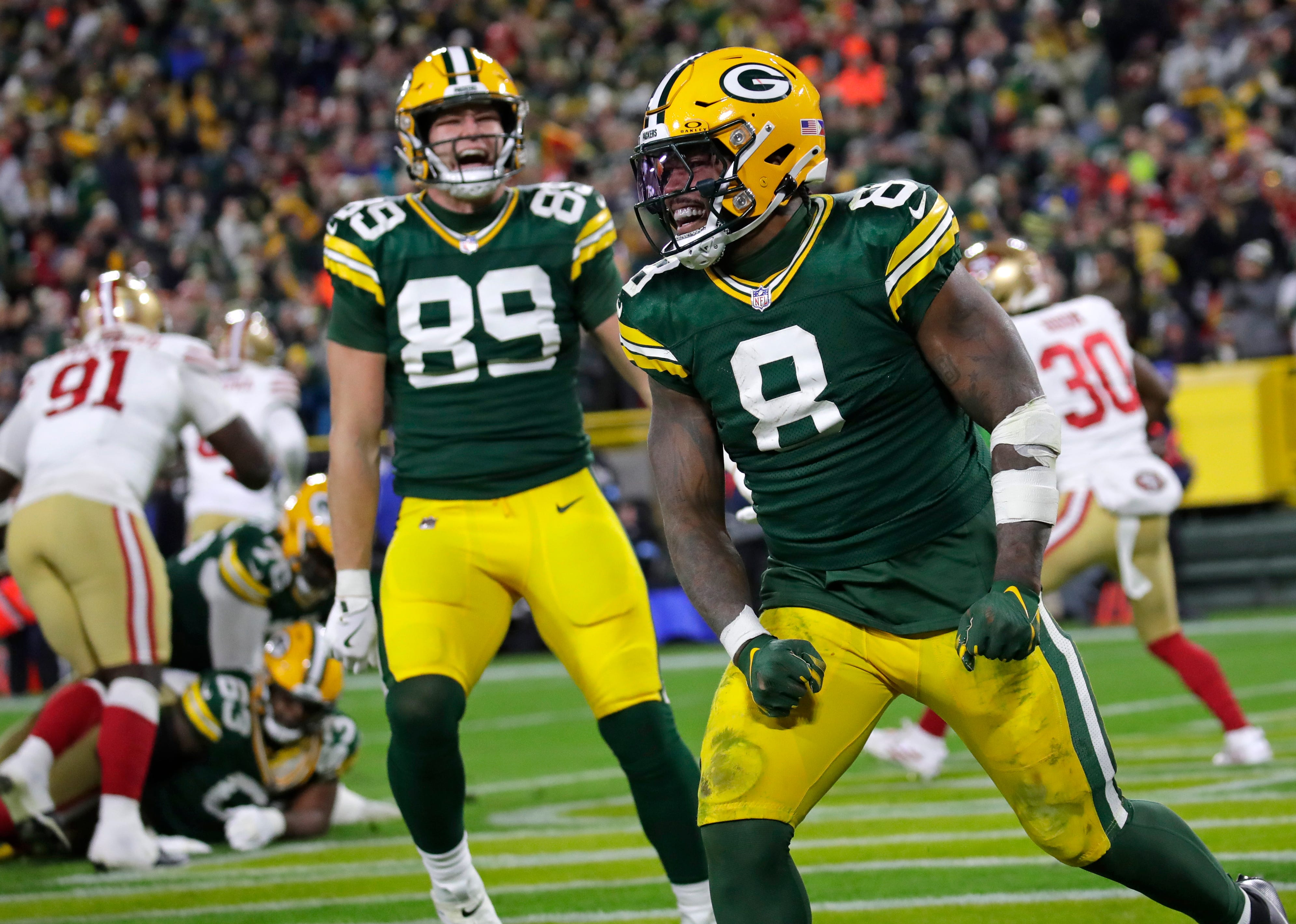Green Bay Packers running back Josh Jacobs (8) celebrates scoring a touchdown in the third quarter against the San Francisco 49ers during their football game Sunday, November 24, 2024, at Lambeau Field in Green Bay, Wisconsin.