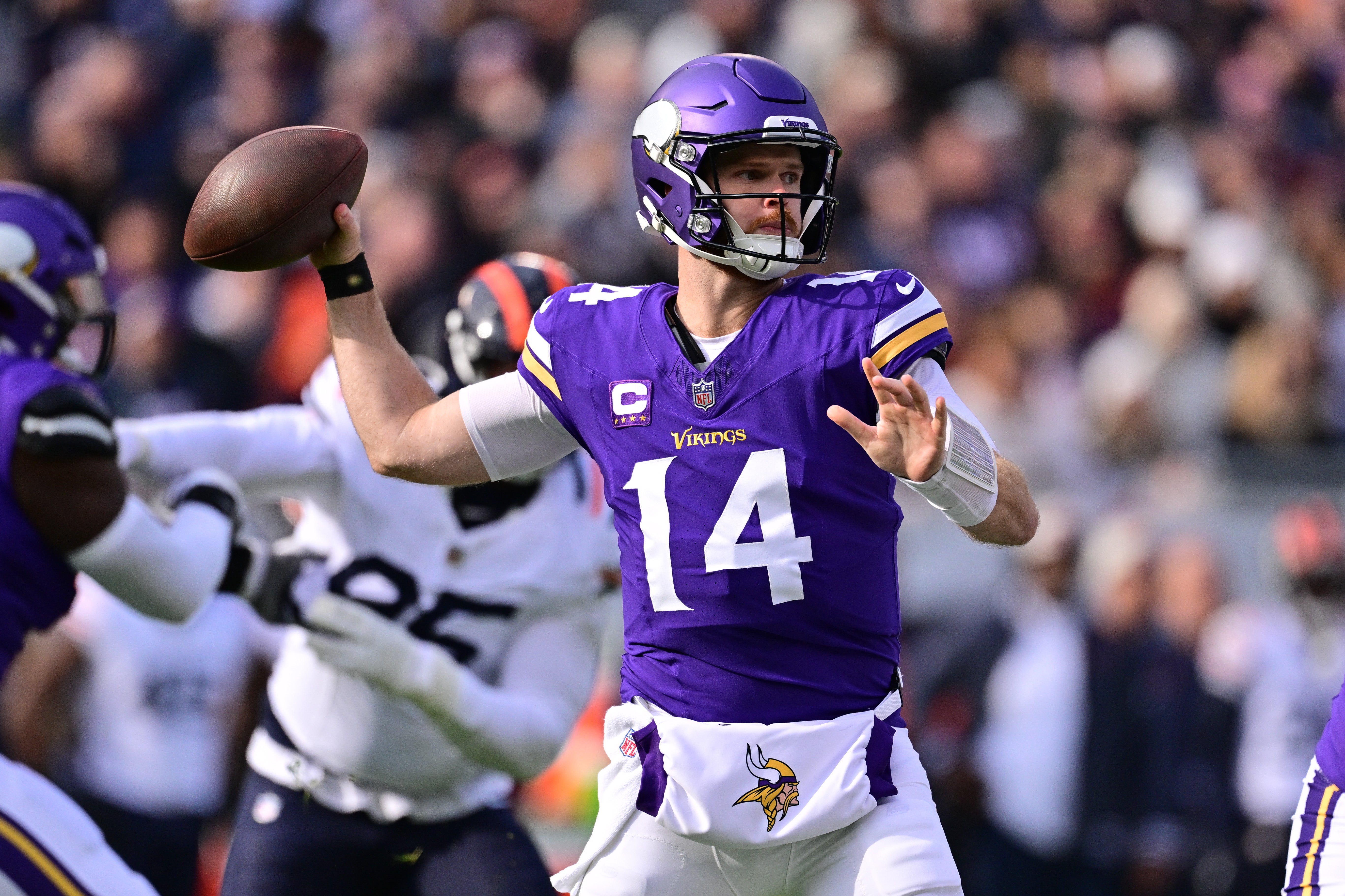 Nov 24, 2024; Chicago, Illinois, USA; Minnesota Vikings quarterback Sam Darnold (14) passes the ball against the Chicago Bears during the first quarter at Soldier Field.