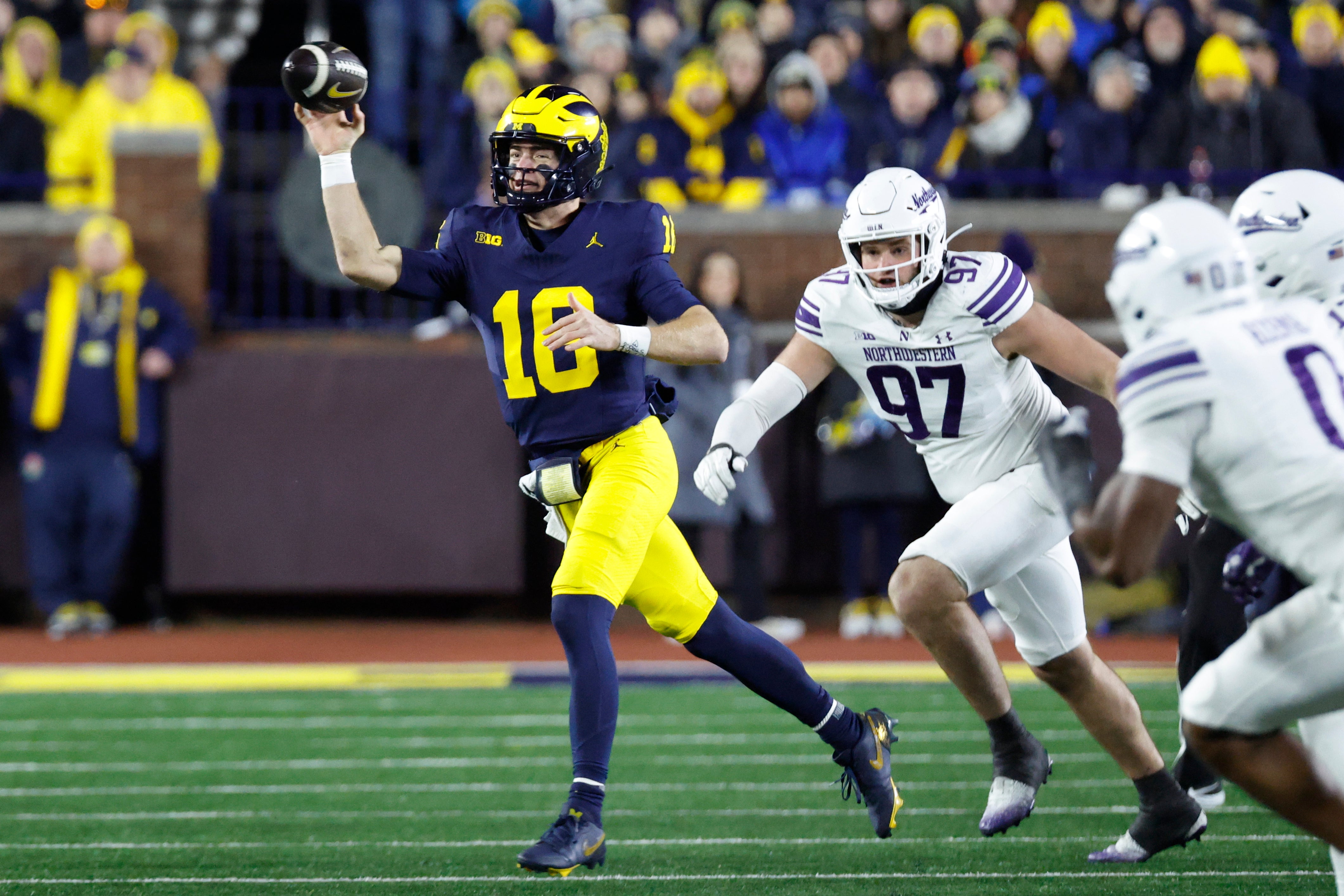 Michigan Wolverines quarterback Davis Warren (16) throws the ball against the Northwestern Wildcats in the second half at Michigan Stadium.