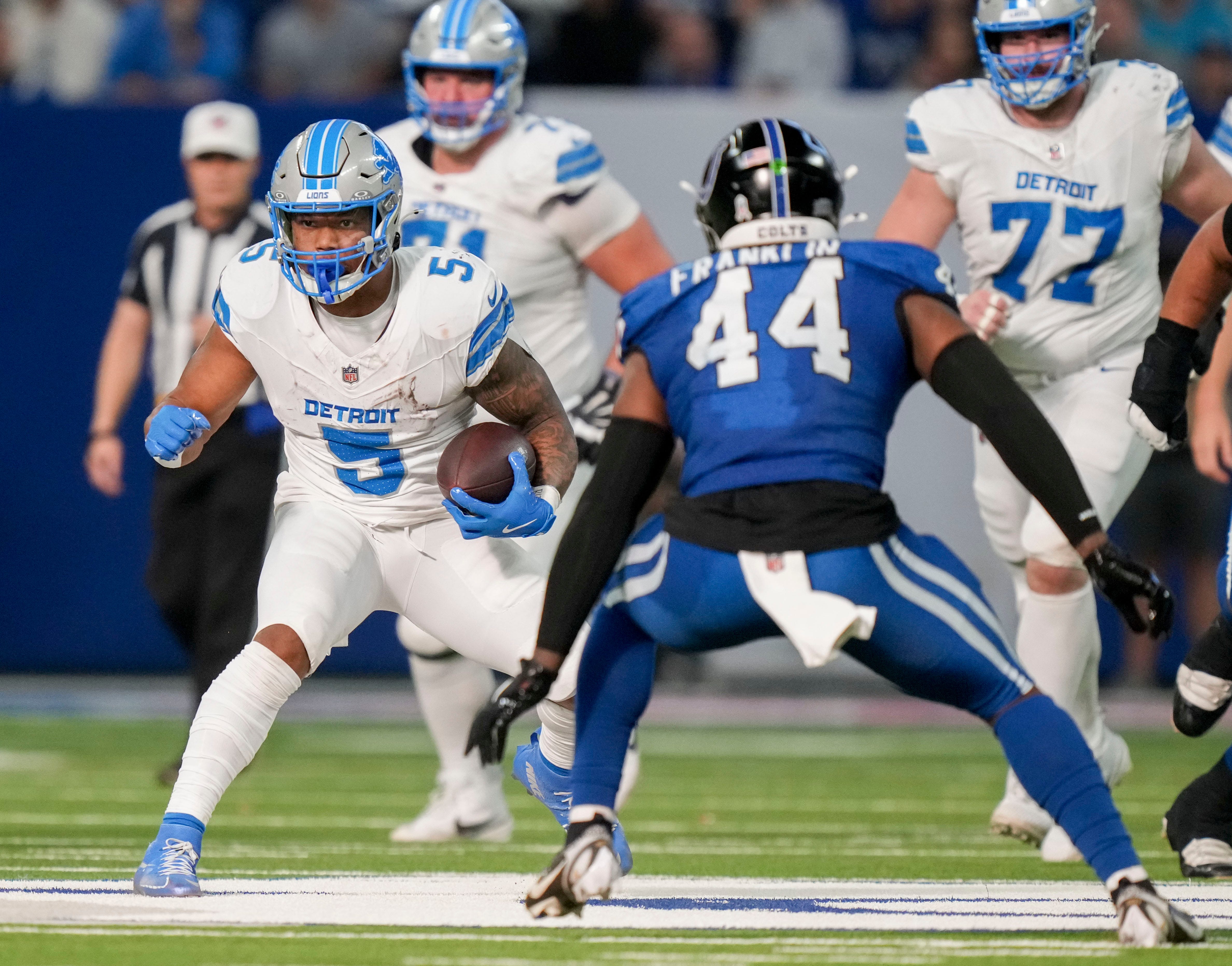 Detroit Lions running back David Montgomery (5) looks to move past Indianapolis Colts linebacker Zaire Franklin (44) on Sunday, Nov. 24, 2024, during a game at Lucas Oil Stadium in Indianapolis.