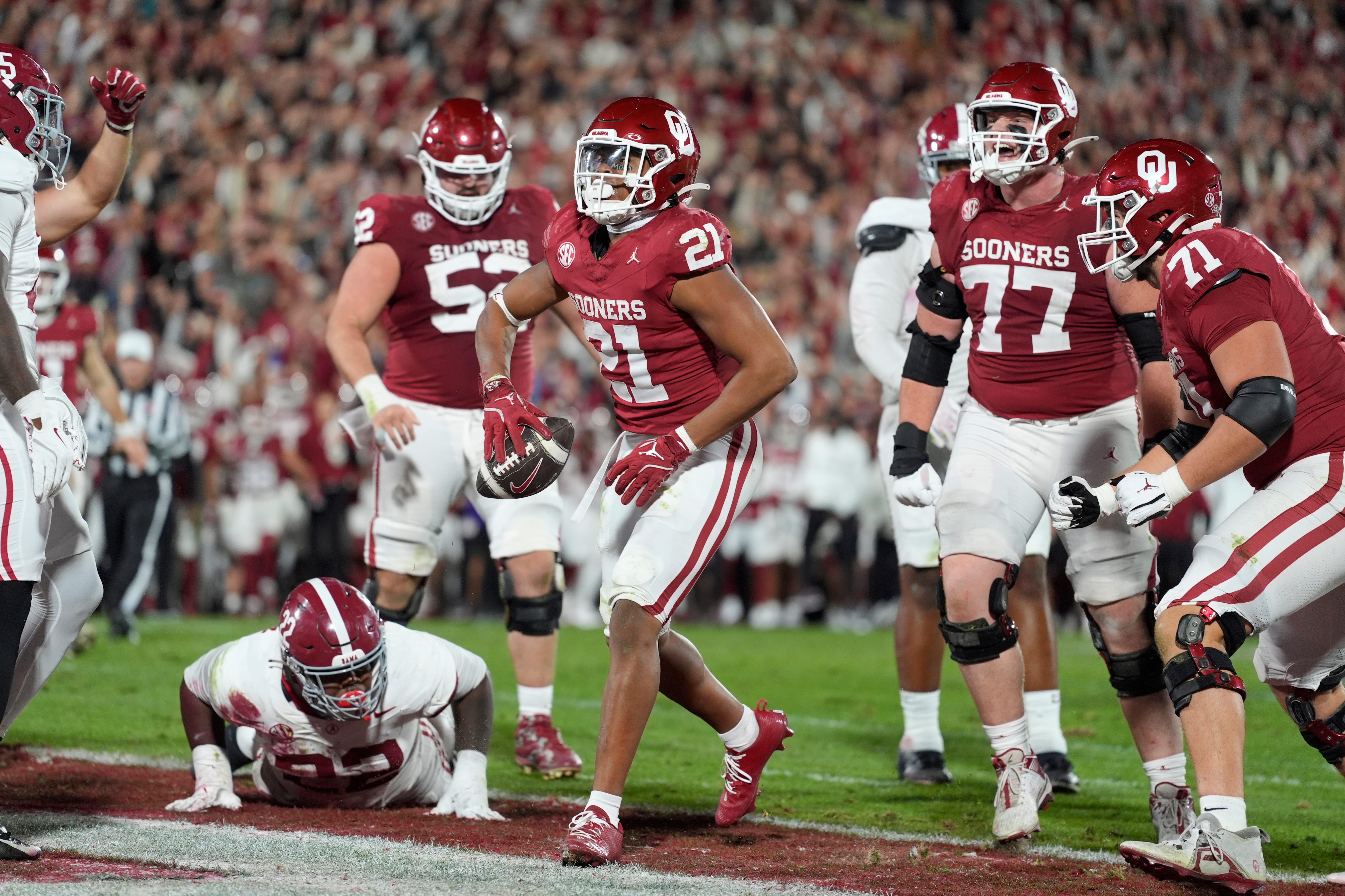 Oklahoma Sooners running back Xavier Robinson (21) celebrates after rushing for a touchdown during a college football game between the University of Oklahoma Sooners (OU) and the Alabama Crimson Tide at Gaylord Family - Oklahoma Memorial Stadium in Norman, Okla., Saturday, Nov. 23, 2024. Oklahoma won 24-3.
