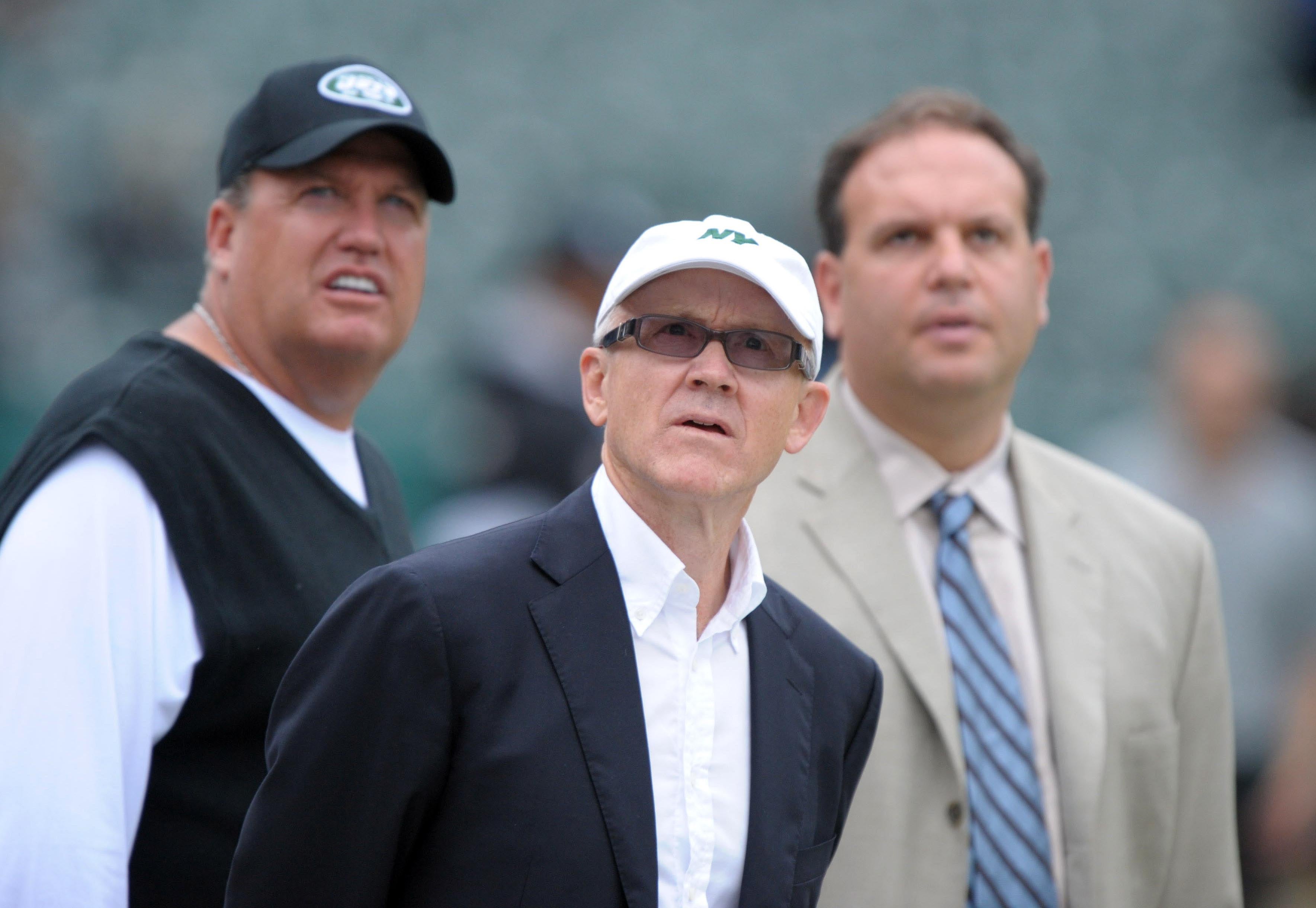 New York Jets owner Woody Johnson (center), coach Rex Ryan (left) and general manager Mike Tannenbaum on the sidelines before the game against the Oakland Raiders at O.co Coliseum.
