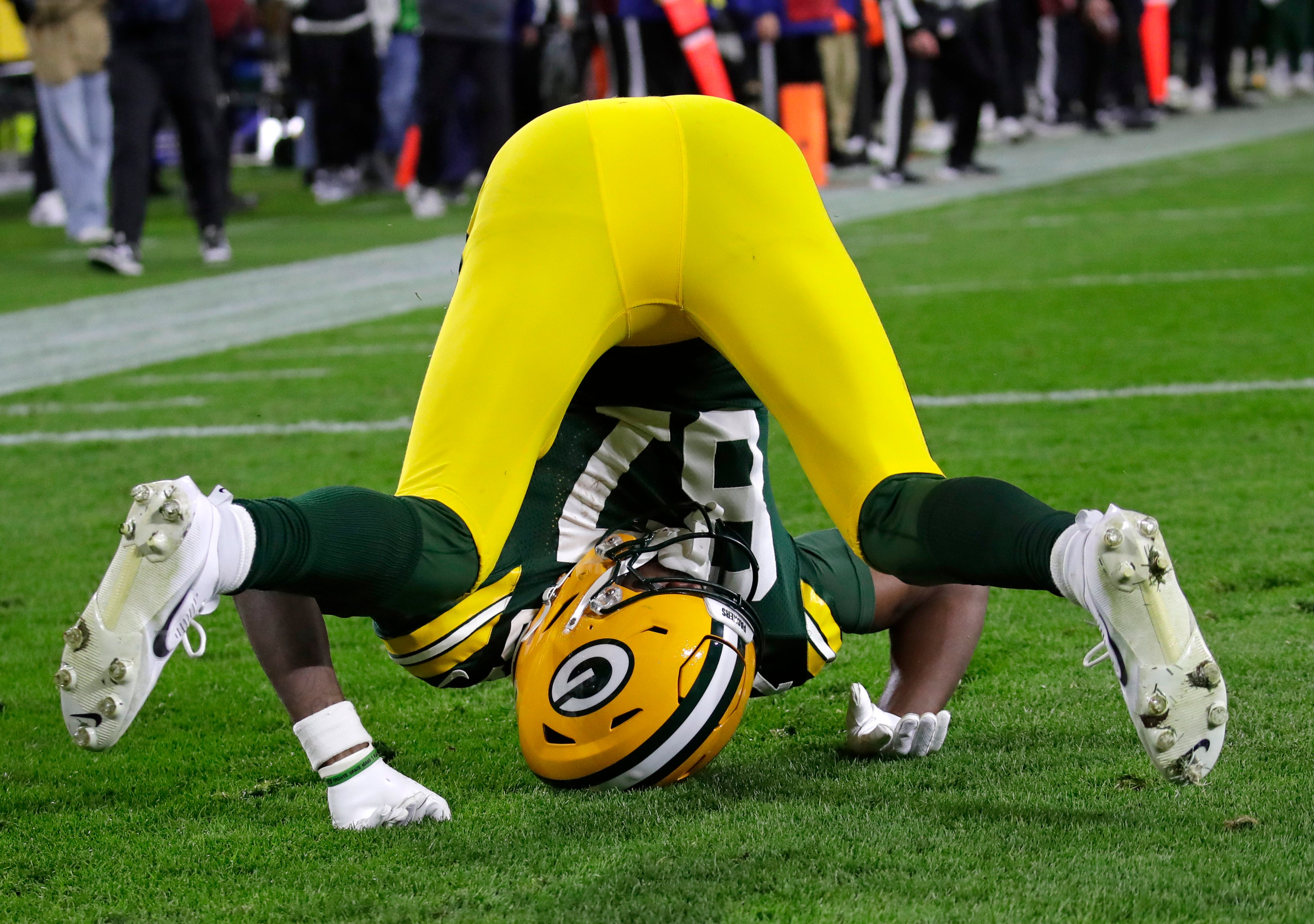 Green Bay Packers wide receiver Romeo Doubs (87) lands awkwardly after a pass interference in the endzone by San Francisco 49ers cornerback Renardo Green (0) during their football game Sunday, November 24, 2024, at Lambeau Field in Green Bay, Wisconsin.