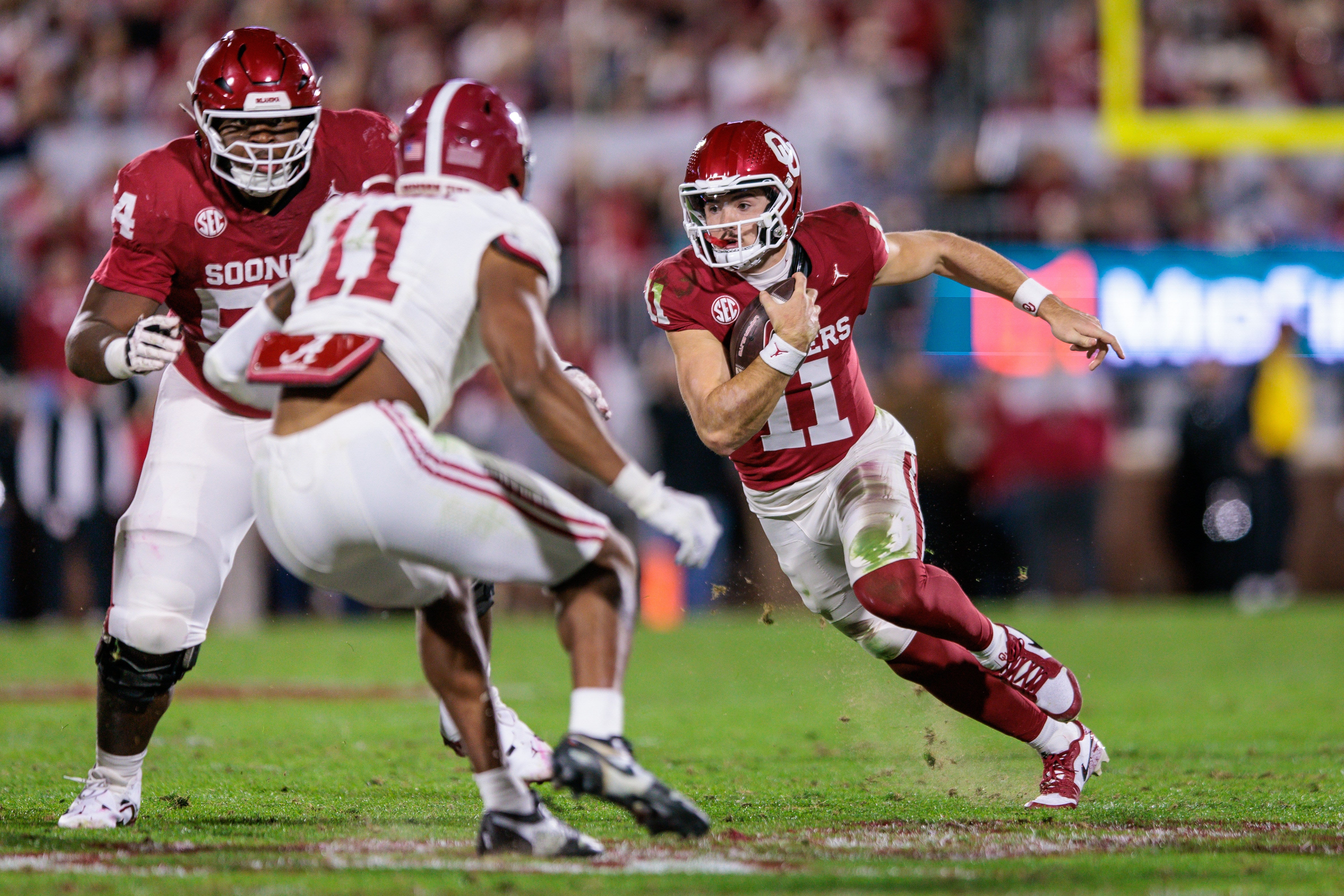 Nov 23, 2024; Norman, Oklahoma, USA; Oklahoma Sooners quarterback Jackson Arnold (11) runs the ball during the second quarter against the Alabama Crimson Tide at Gaylord Family-Oklahoma Memorial Stadium.