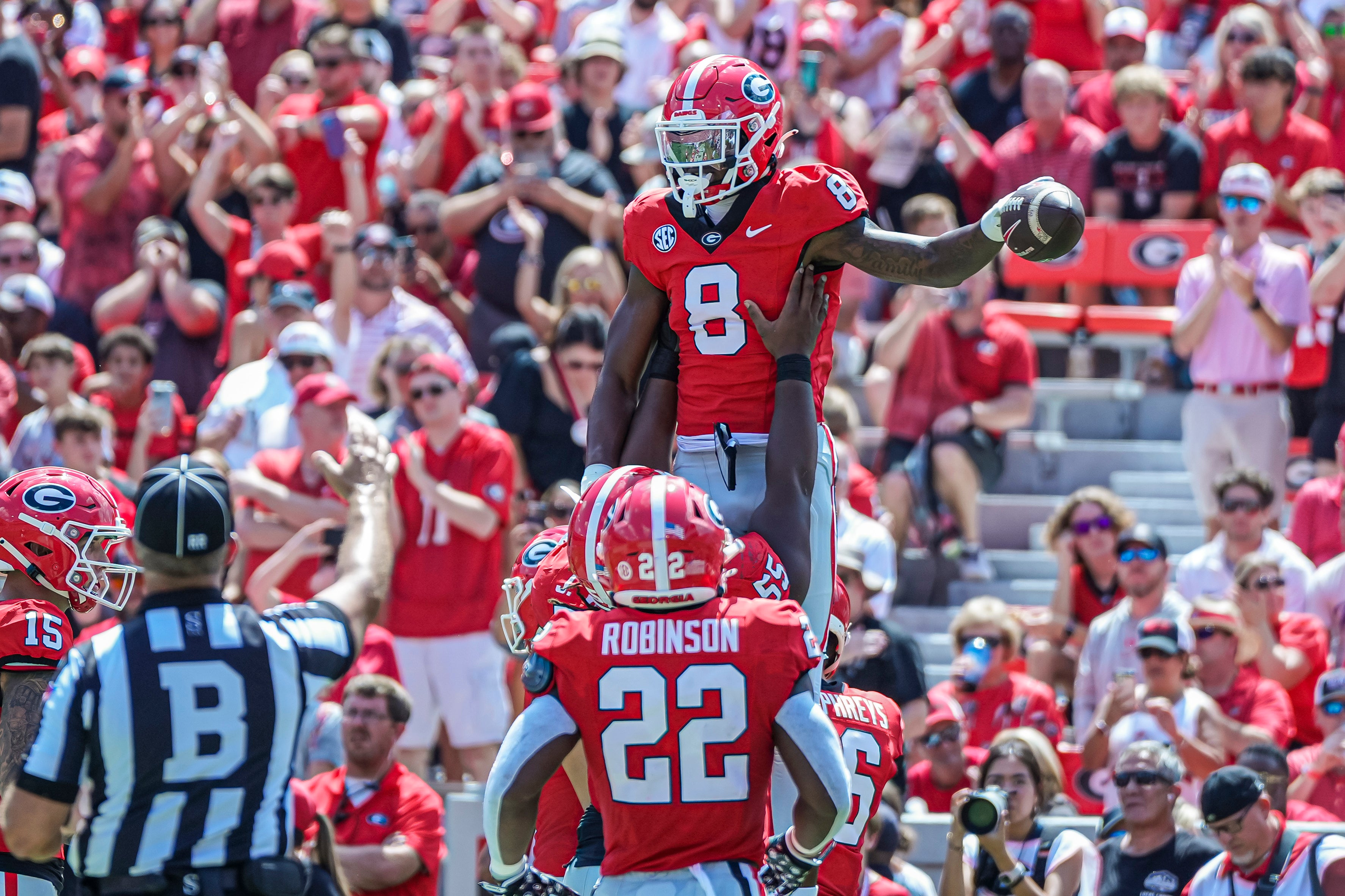 Georgia Bulldogs wide receiver Colbie Young (8) gets a lift from teammates after scoring a touchdown against the Tennessee Tech Golden Eagles during the first half at Sanford Stadium.
