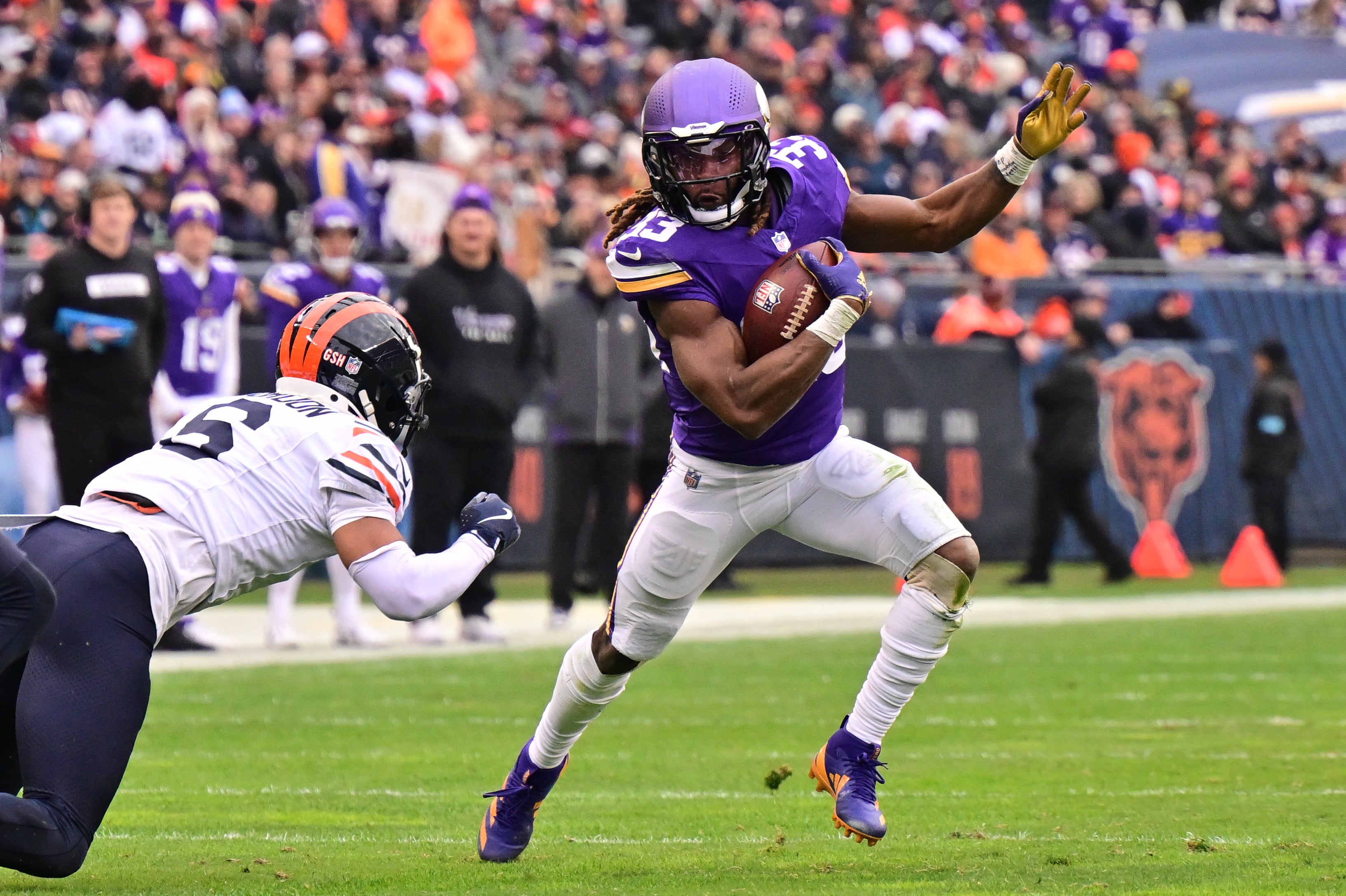 Nov 24, 2024; Chicago, Illinois, USA; Minnesota Vikings running back Aaron Jones (33) runs after a catch against the Chicago Bears during the third quarter at Soldier Field. M
