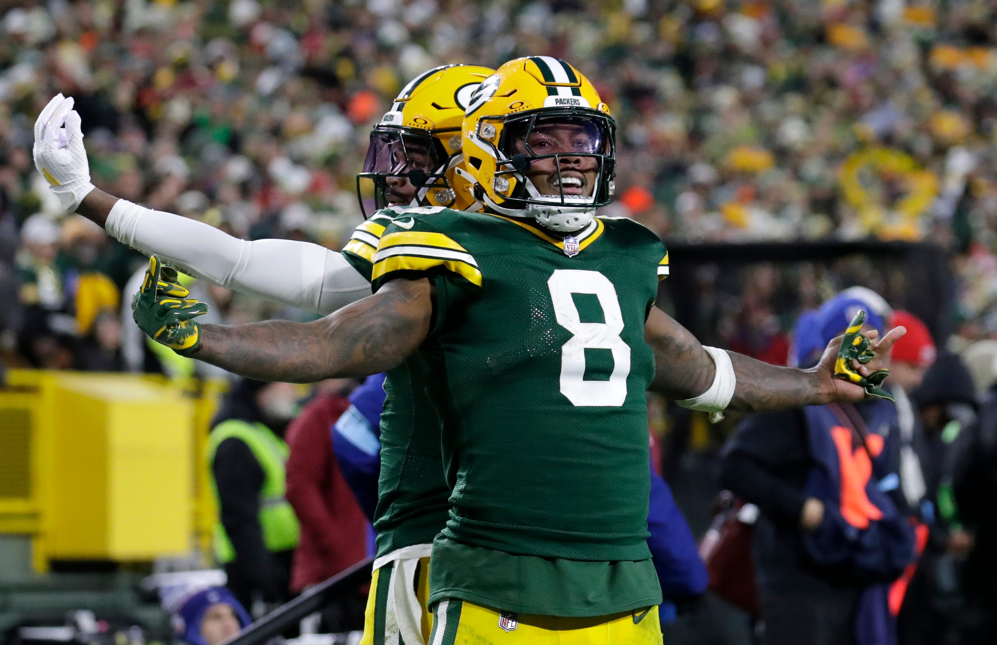 Packers running back Josh Jacobs (8) celebrates scoring a touchdown with wide receiver Bo Melton (80)