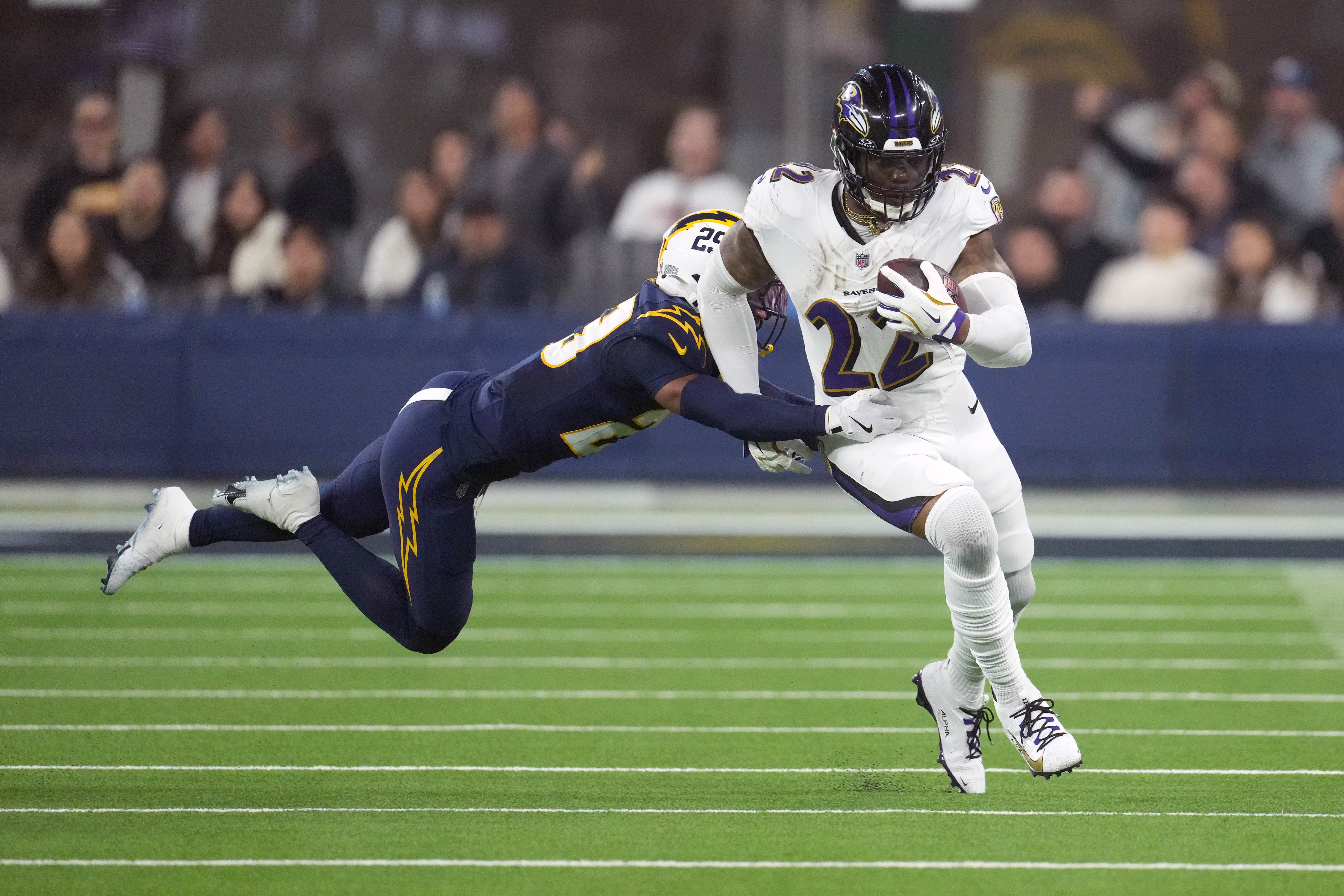 Ravens running back Derrick Henry (22) carries the ball against Los Angeles Chargers cornerback Tarheeb Still (29).