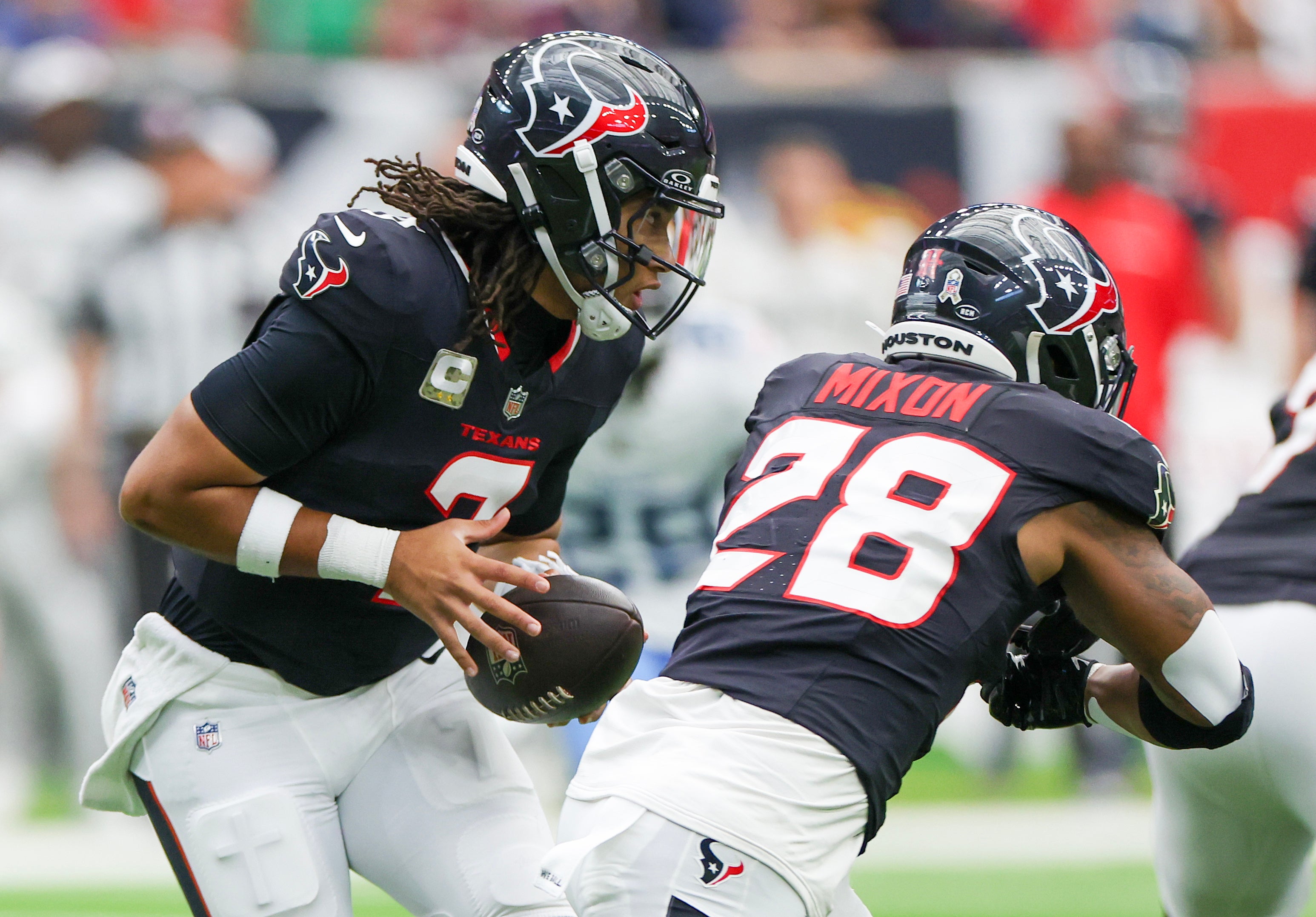 Nov 24, 2024; Houston, Texas, USA; Houston Texans quarterback C.J. Stroud (7) fakes the hand-off to Houston Texans running back Joe Mixon (28) in the first quarter at NRG Stadium.