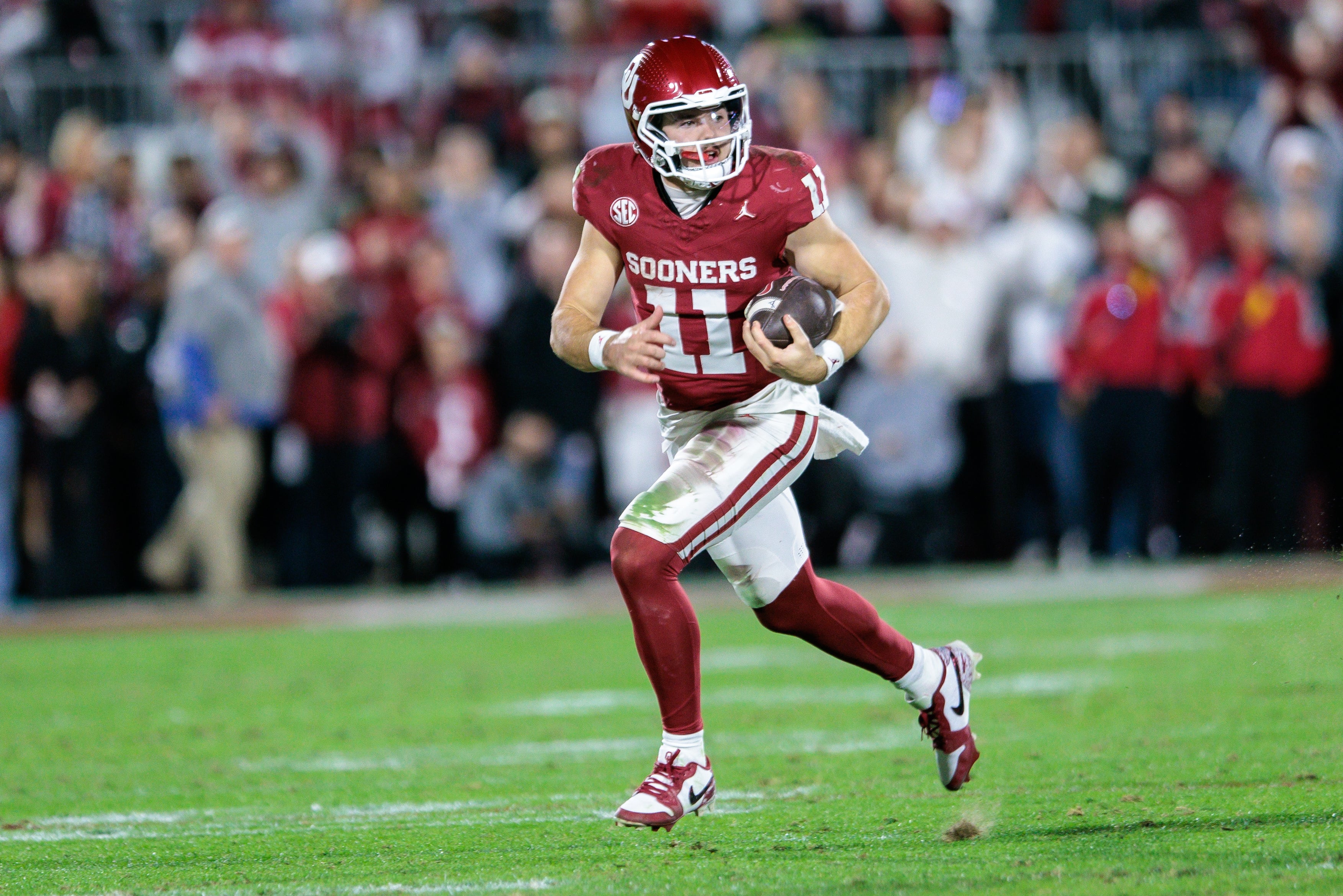Nov 23, 2024; Norman, Oklahoma, USA; Oklahoma Sooners quarterback Jackson Arnold (11) runs the ball during the fourth quarter against the Alabama Crimson Tide at Gaylord Family-Oklahoma Memorial Stadium.