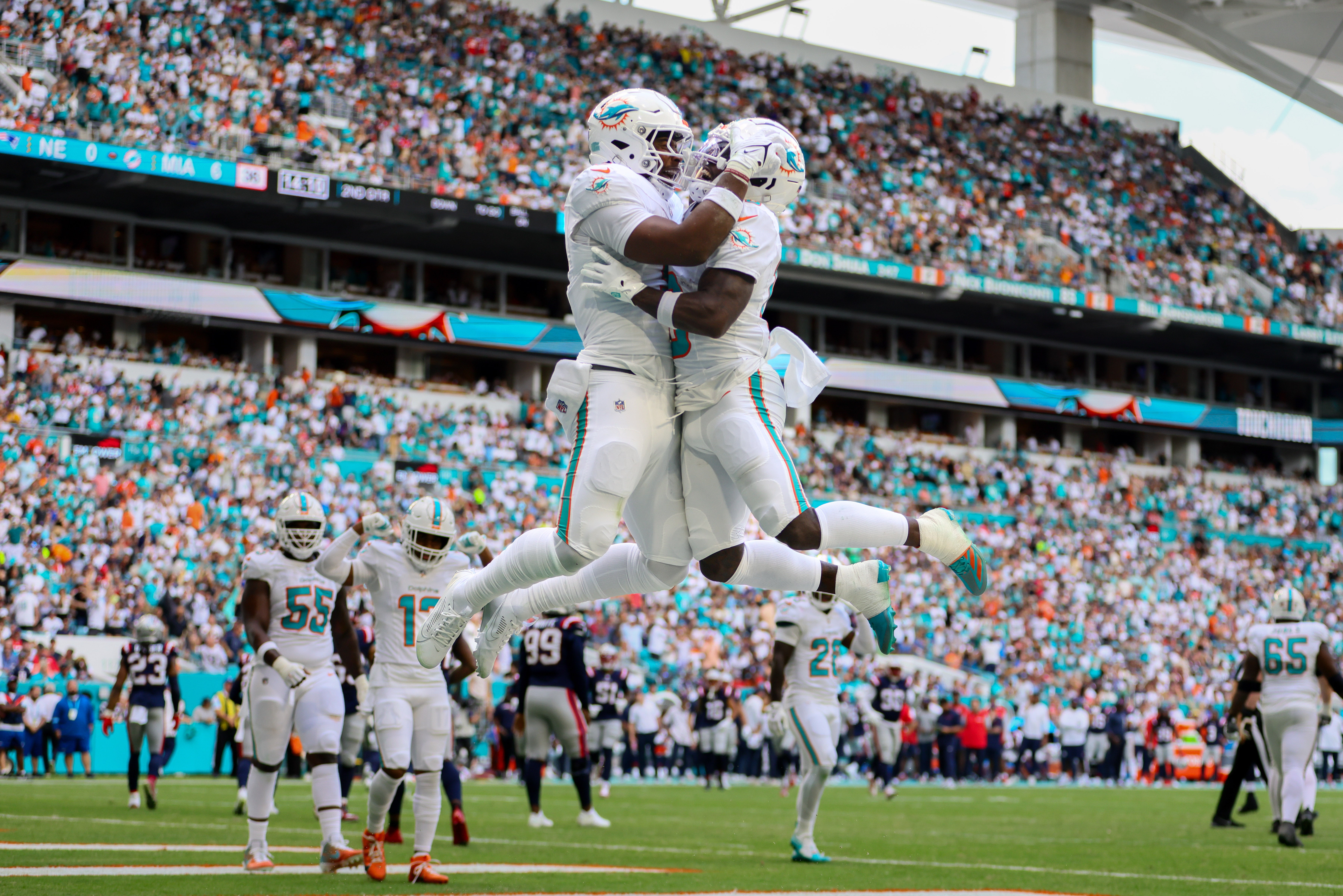 Nov 24, 2024; Miami Gardens, Florida, USA; Miami Dolphins tight end Jonnu Smith (9) celebrates with wide receiver Tyreek Hill (10) after scoring a touchdown against the New England Patriots during the first quarter at Hard Rock Stadium.