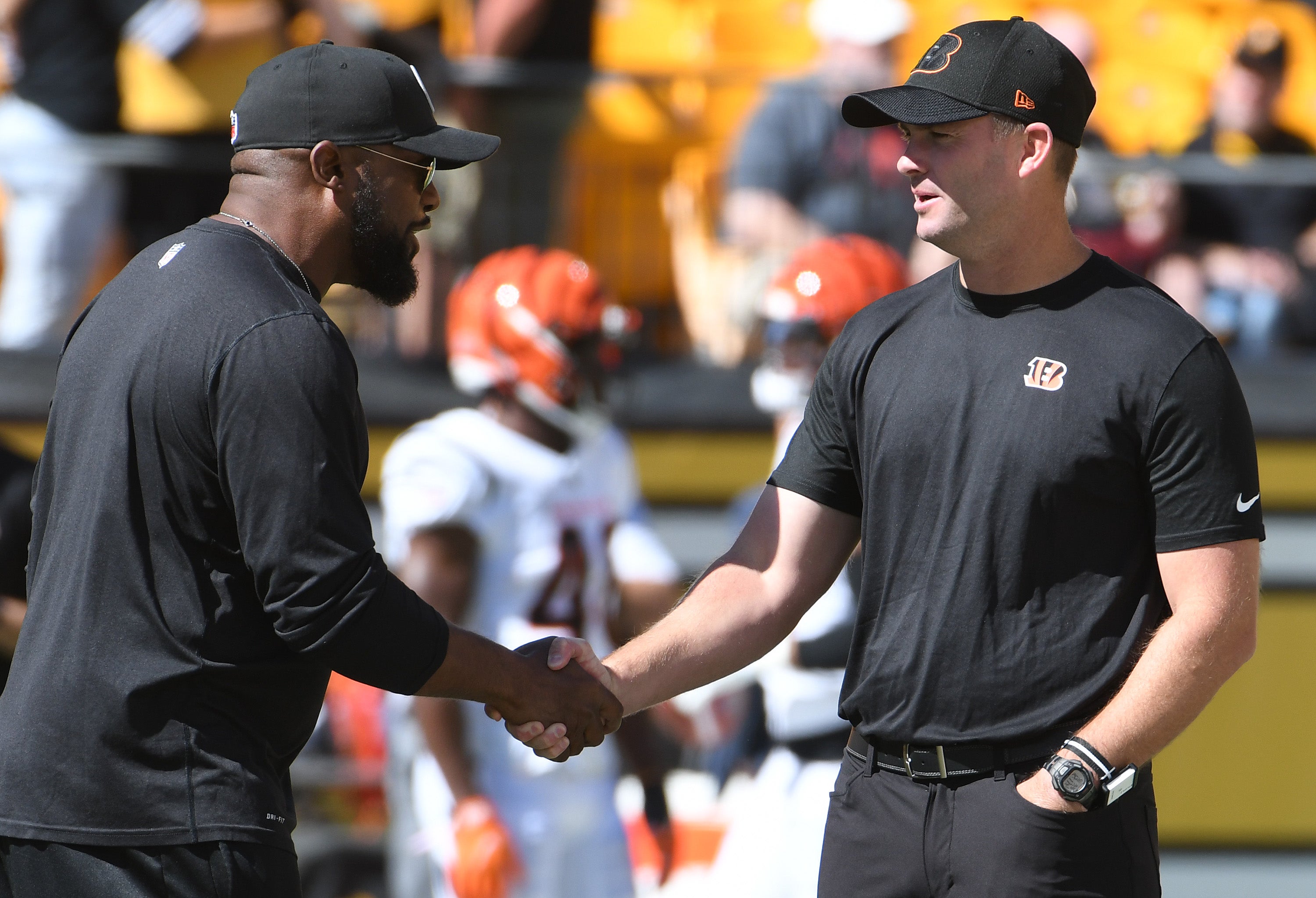 Sep 26, 2021; Pittsburgh, Pennsylvania, USA; Pittsburgh Steelers head coach Mike Tomlin (left) meets with Cincinnati Bengals head coach Zac Taylor before their teams play each other at Heinz Field.
