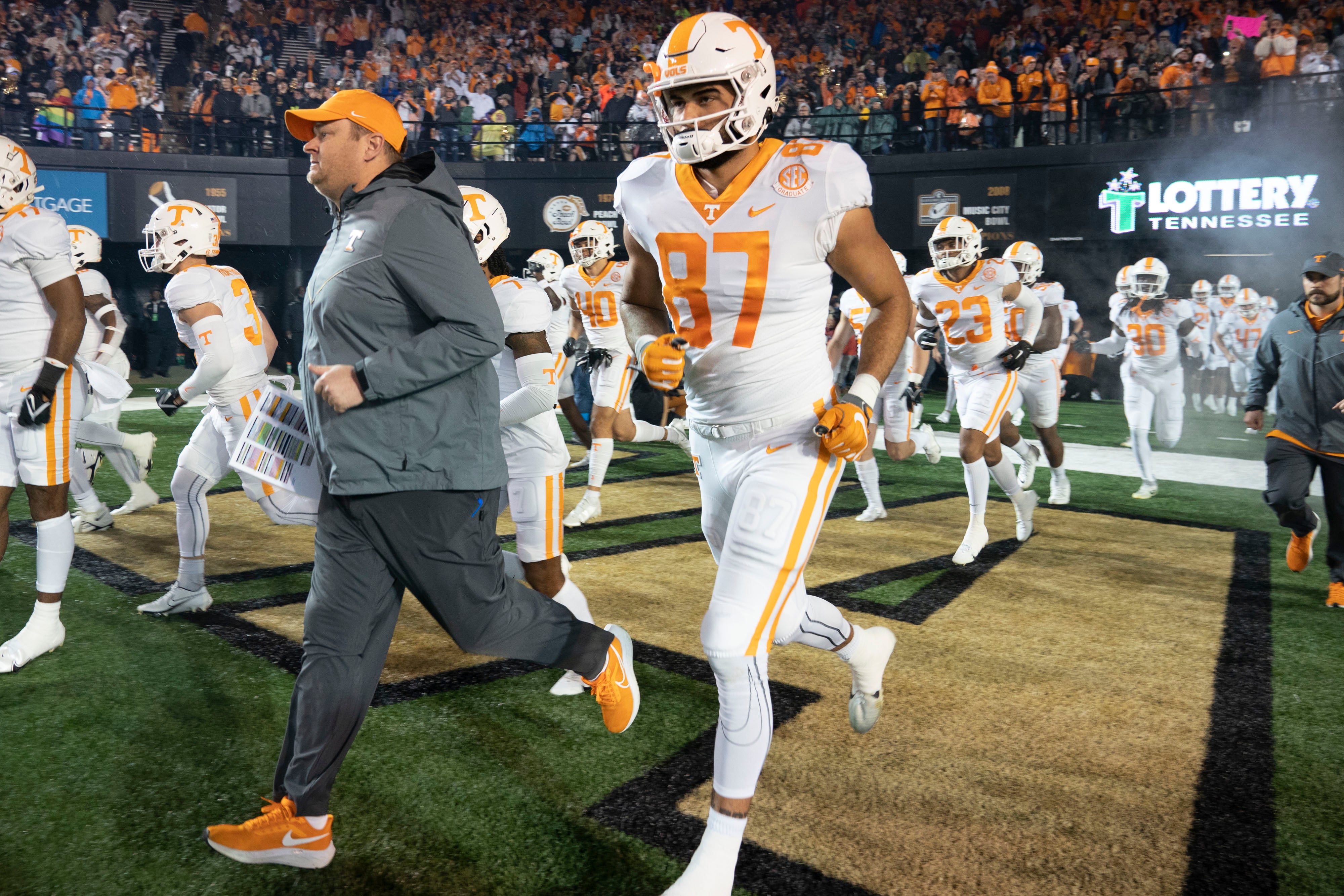 Nov 26, 2022; Nashville, Tennessee, USA; Tennessee Volunteers head coach Josh Heupel leads his players on to the field before a game against the Vanderbilt Commodores at FirstBank Stadium.