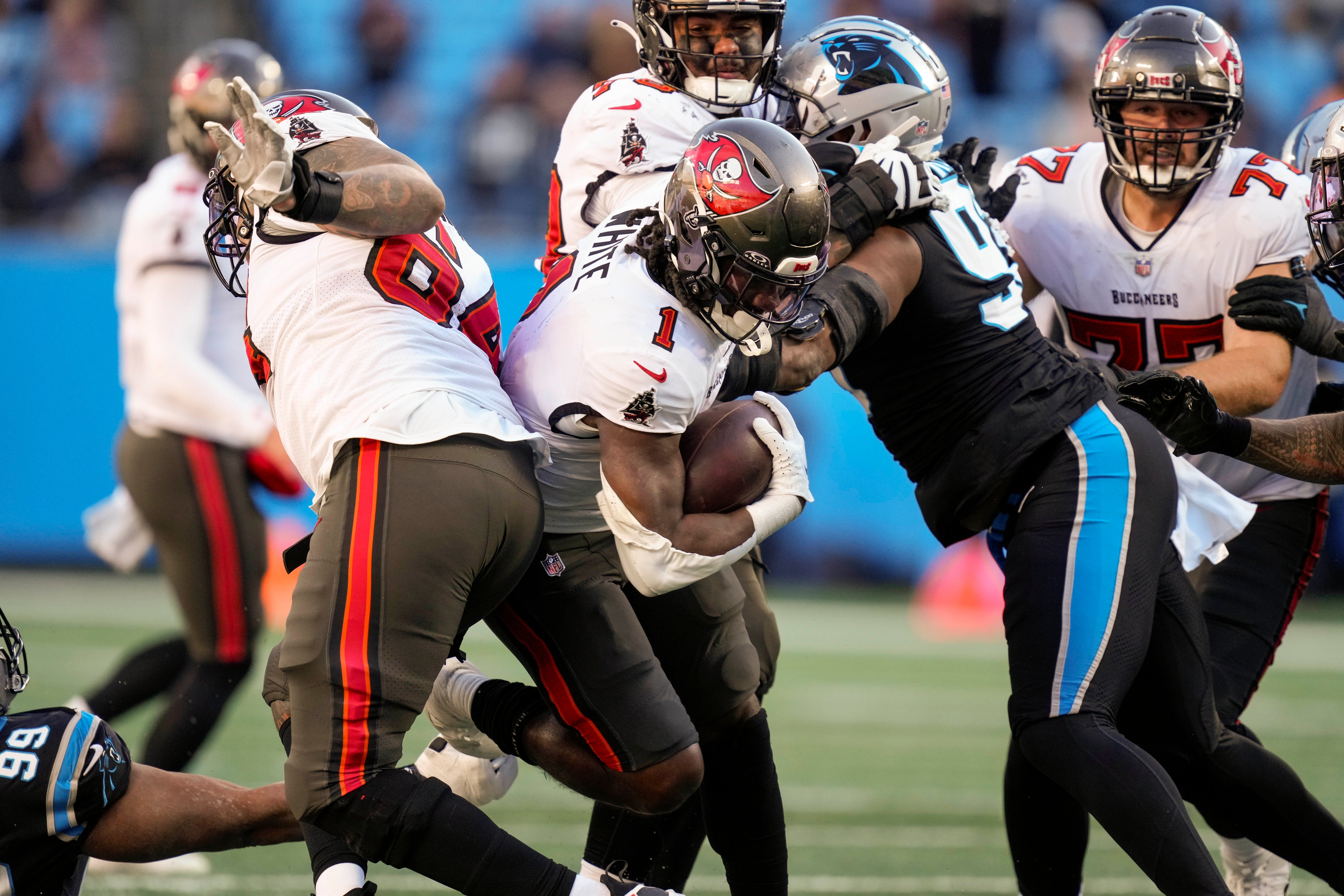 Jan 7, 2024; Charlotte, North Carolina, USA; Tampa Bay Buccaneers running back Rachaad White (1) is tackled by Carolina Panthers defensive tackle Derrick Brown (95) during the second half at Bank of America Stadium.