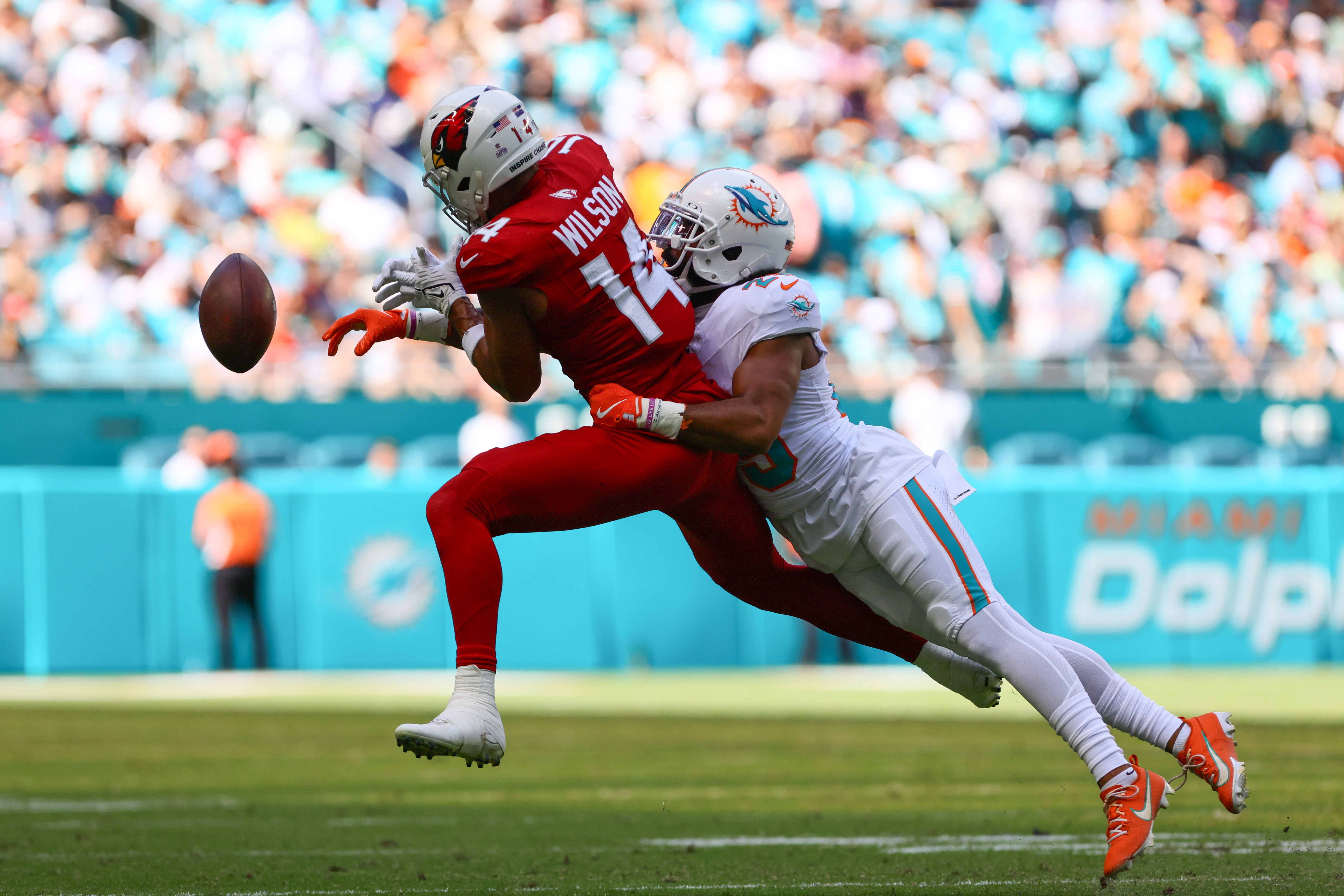 Oct 27, 2024; Miami Gardens, Florida, USA; Miami Dolphins cornerback Kendall Fuller (29) breaks a pass intended to Arizona Cardinals wide receiver Michael Wilson (14) during the second quarter at Hard Rock Stadium.
