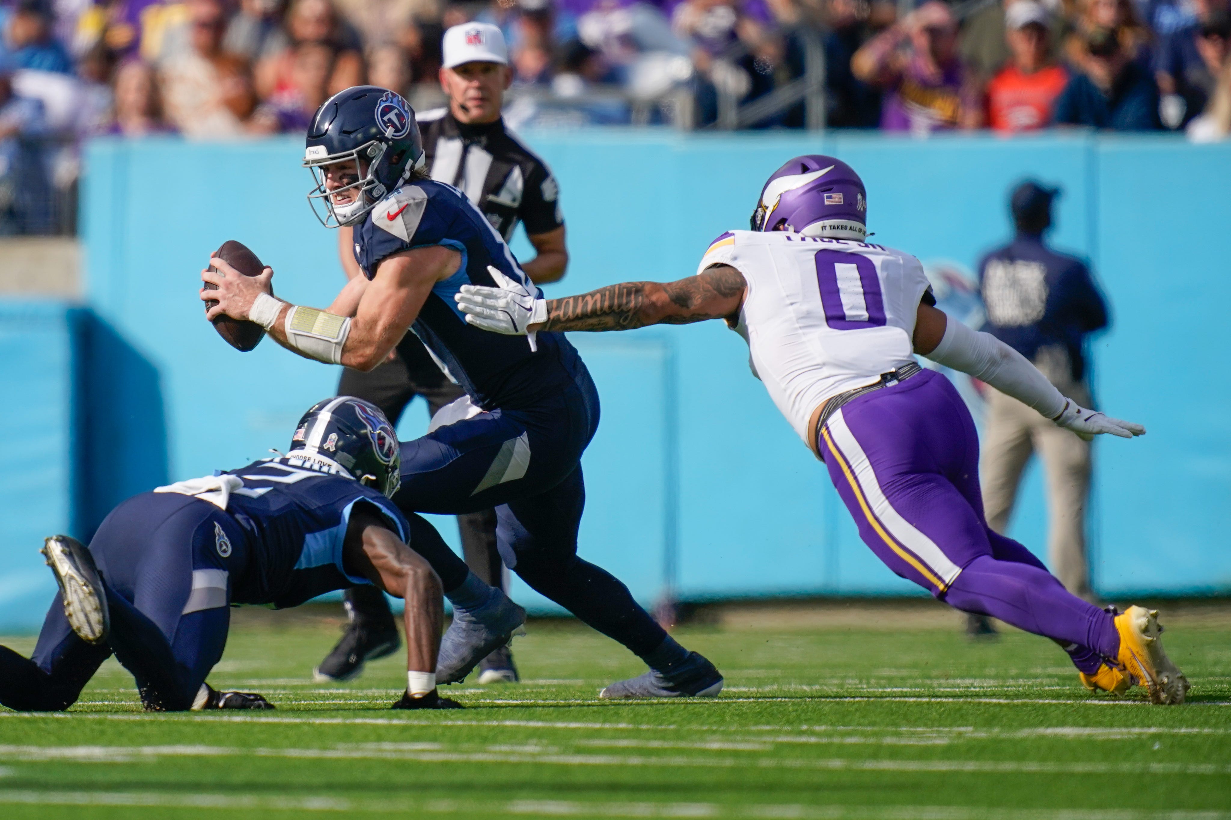 Tennessee Titans quarterback Will Levis (8) looks downfield under pressure from Minnesota Vikings linebacker Ivan Pace Jr. (0) during the first quarter at Nissan Stadium in Nashville, Tenn., Sunday, Nov. 17, 2024.