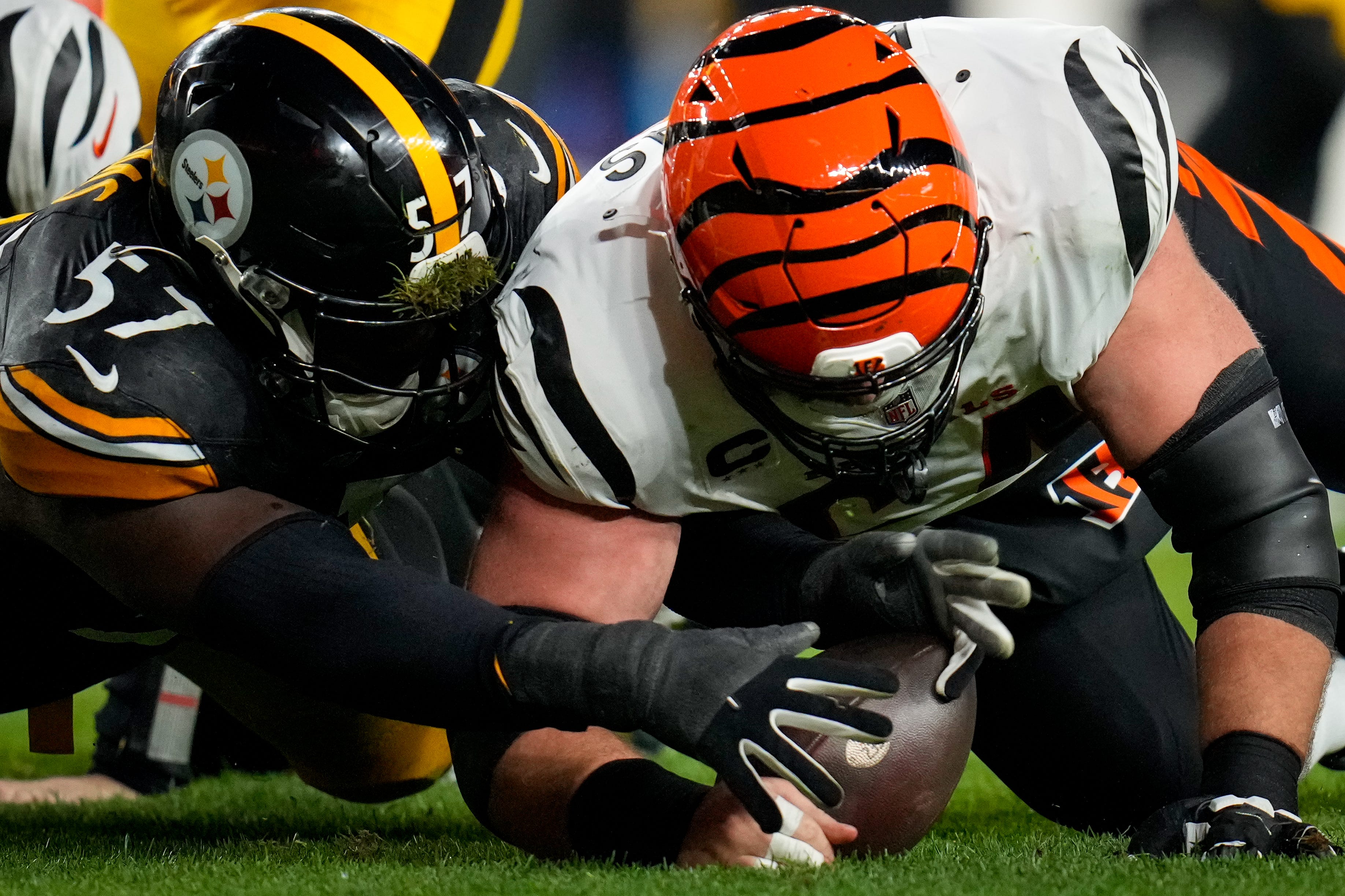 Pittsburgh Steelers defensive tackle Montravius Adams (57) and Cincinnati Bengals center Ted Karras (64) dive after a loose ball fumbled by quarterback Jake Browning (6) in the second quarter of the NFL 16 game between the Pittsburgh Steelers and the Cincinnati Bengals at Acrisure Stadium in Pittsburgh on Saturday, Dec. 23, 2023. The Steelers led 24-0 at halftime.