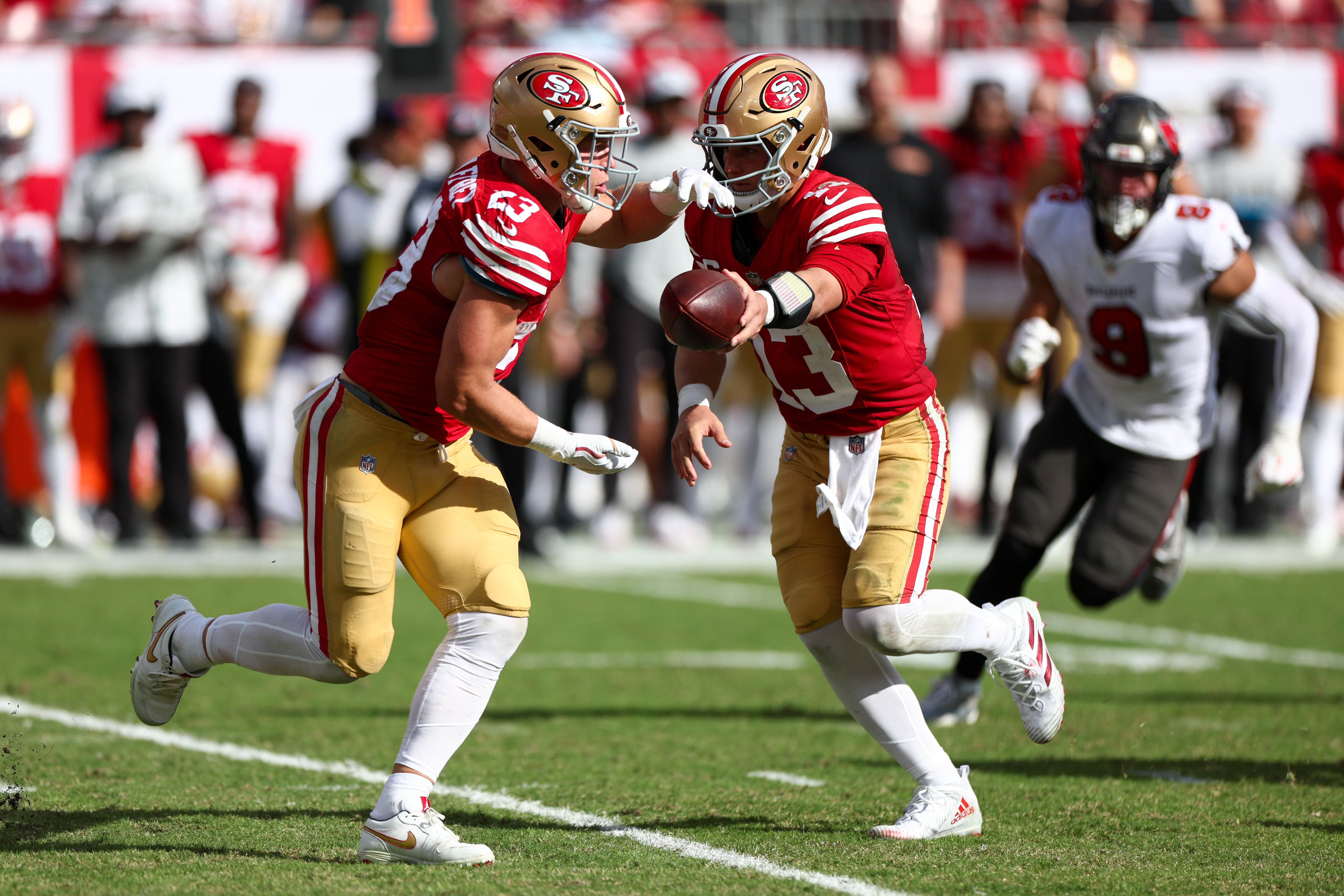 San Francisco 49ers quarterback Brock Purdy (13) hands off to running back Christian McCaffrey (23) against the Tampa Bay Buccaneers in the third quarter at Raymond James Stadium.
