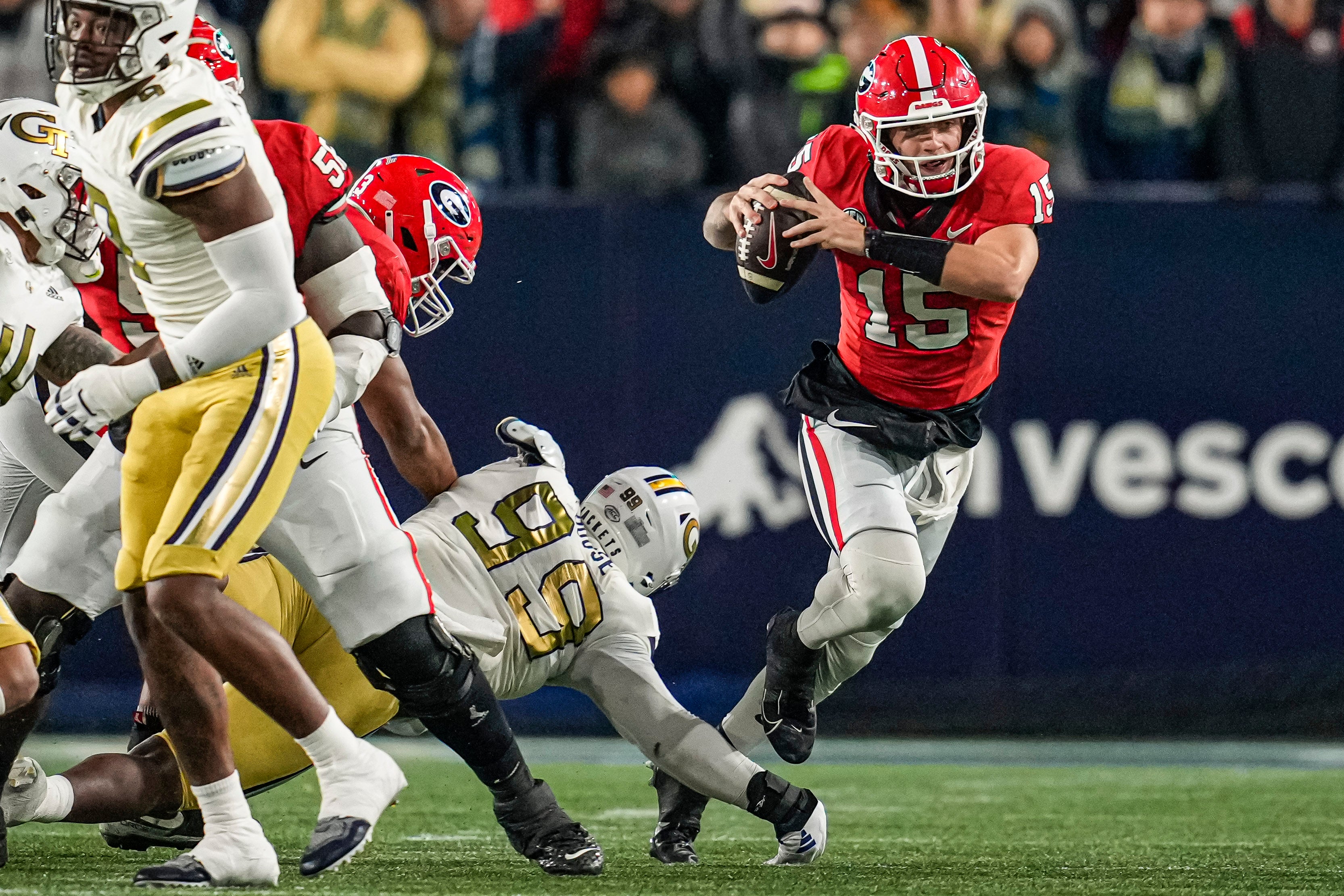 Georgia Bulldogs quarterback Carson Beck (15) breaks a tackle by Georgia Tech Yellow Jackets defensive lineman D'Quan Douse (99) during the first half at Hyundai Field.