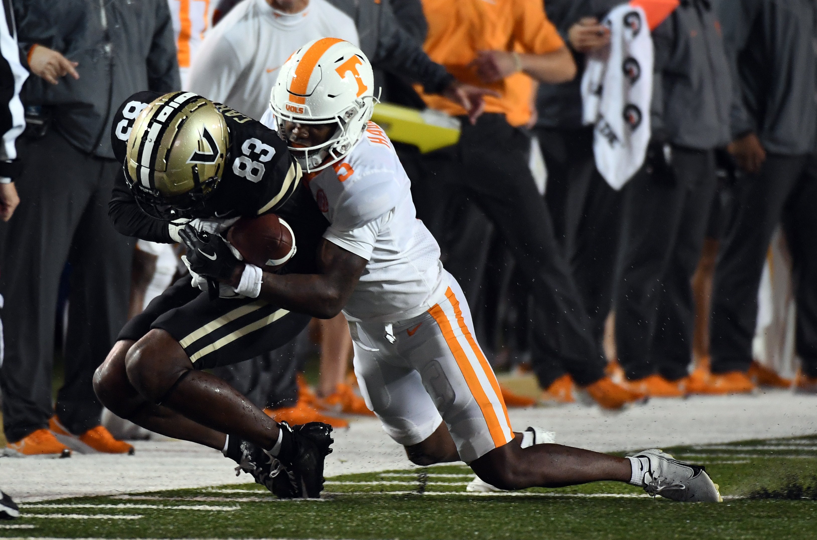 Nov 26, 2022; Nashville, Tennessee, USA; Vanderbilt Commodores wide receiver Gamarion Carter (83) catches a pass against Tennessee Volunteers defensive back Kamal Hadden (5) along the sideline during the second half at FirstBank Stadium.