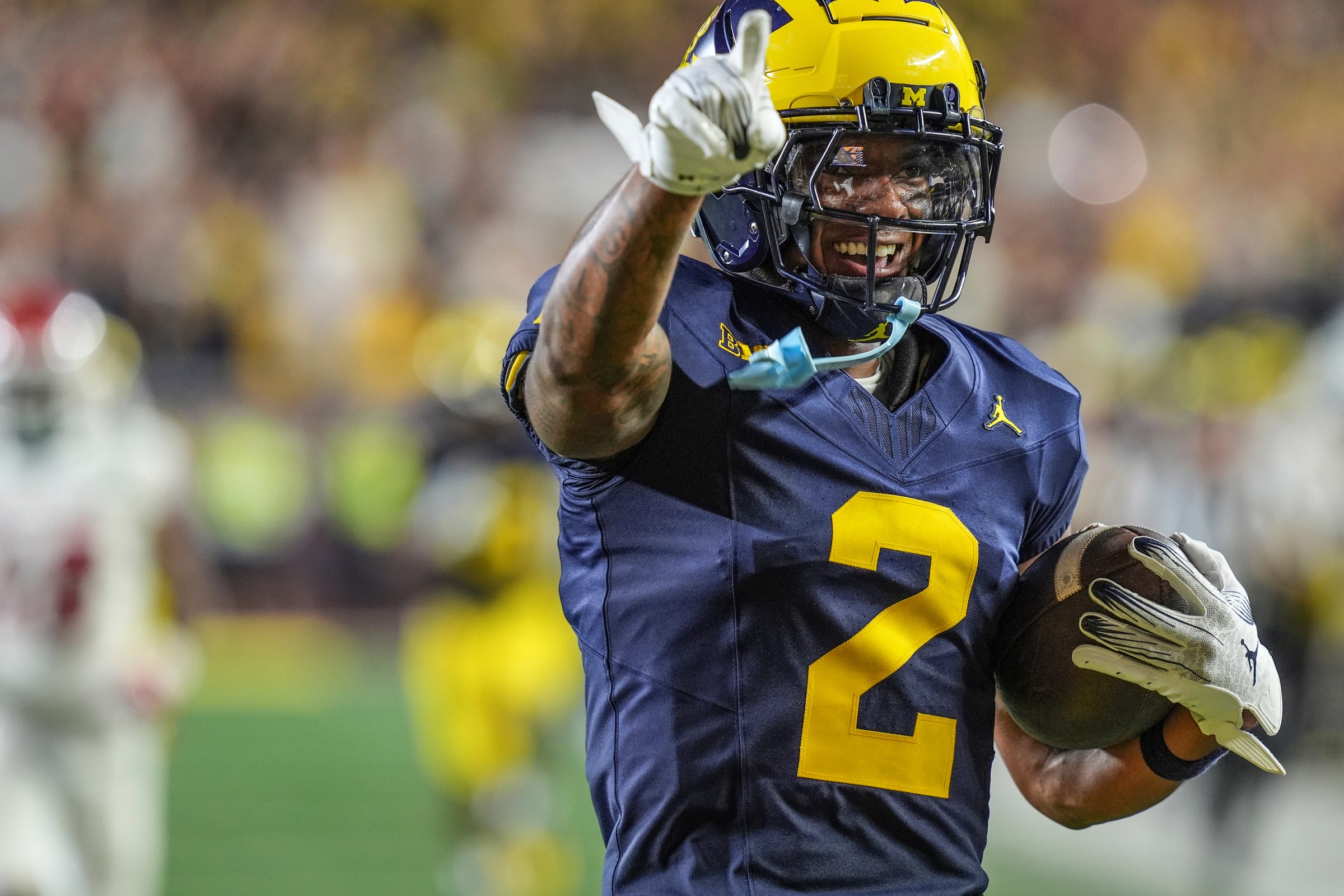 Michigan defensive back Will Johnson (2) celebrates after returning an interception for a touchdown against Fresno State during the second half at Michigan Stadium in Ann Arbor on Saturday, Aug. 31, 2024.