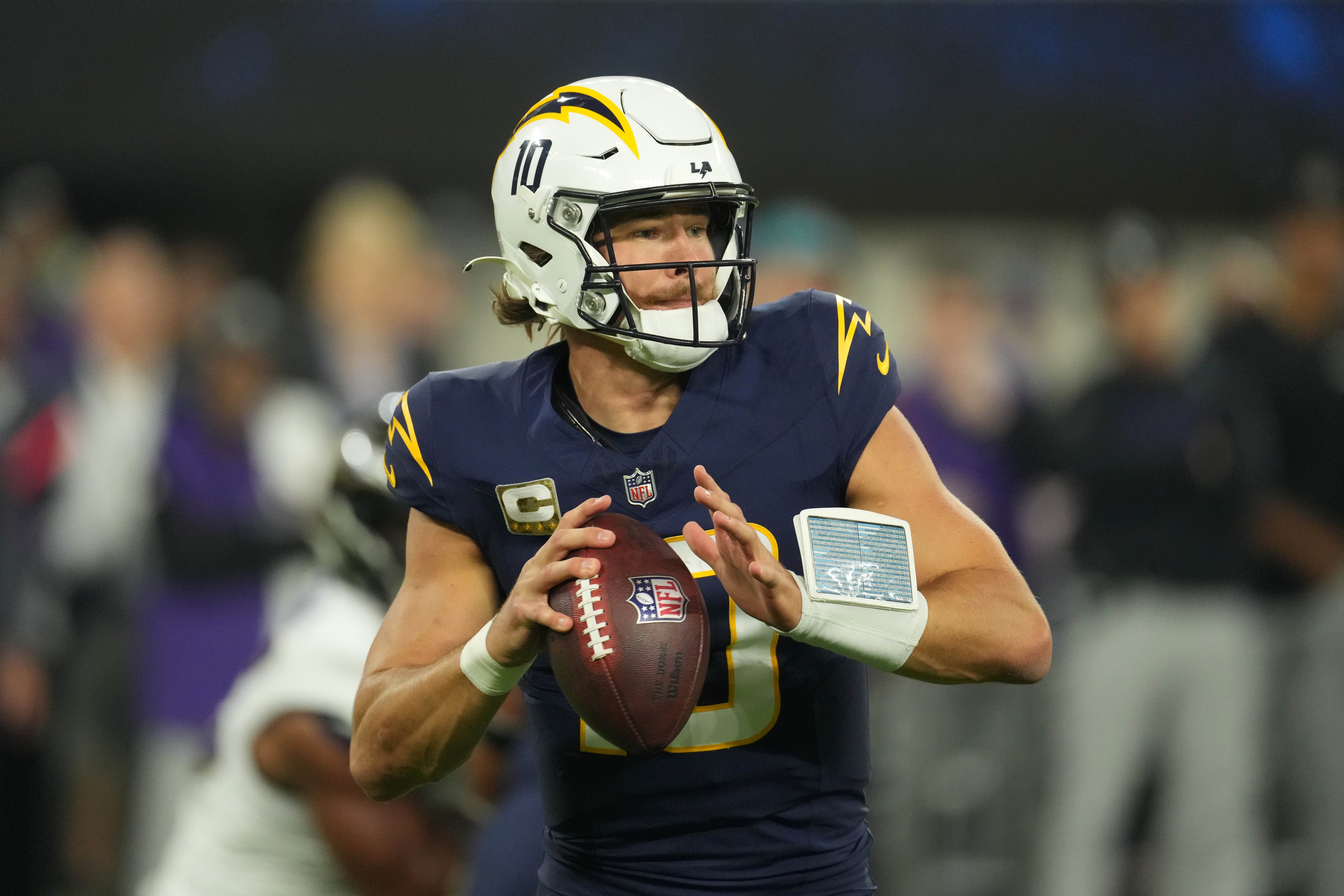 Nov 25, 2024; Inglewood, California, USA; Los Angeles Chargers quarterback Justin Herbert (10) throws the ball against the Baltimore Ravens in the first half at SoFi Stadium.