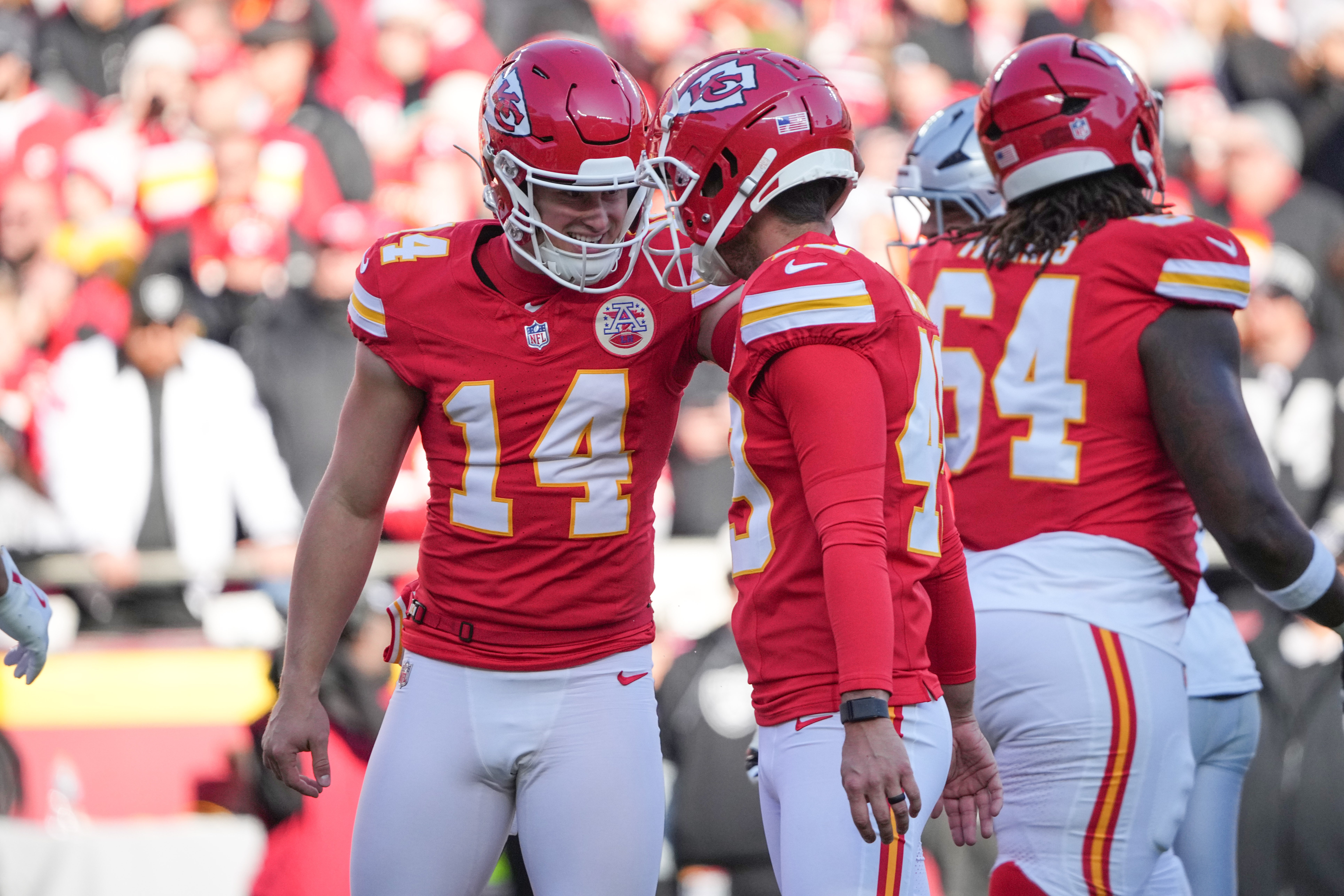 Nov 29, 2024; Kansas City, Missouri, USA; Kansas City Chiefs place kicker Matthew Wright (49) is congratulated by punter Matt Araiza (14) after scoring against the Las Vegas Raiders during the first half at GEHA Field at Arrowhead Stadium.