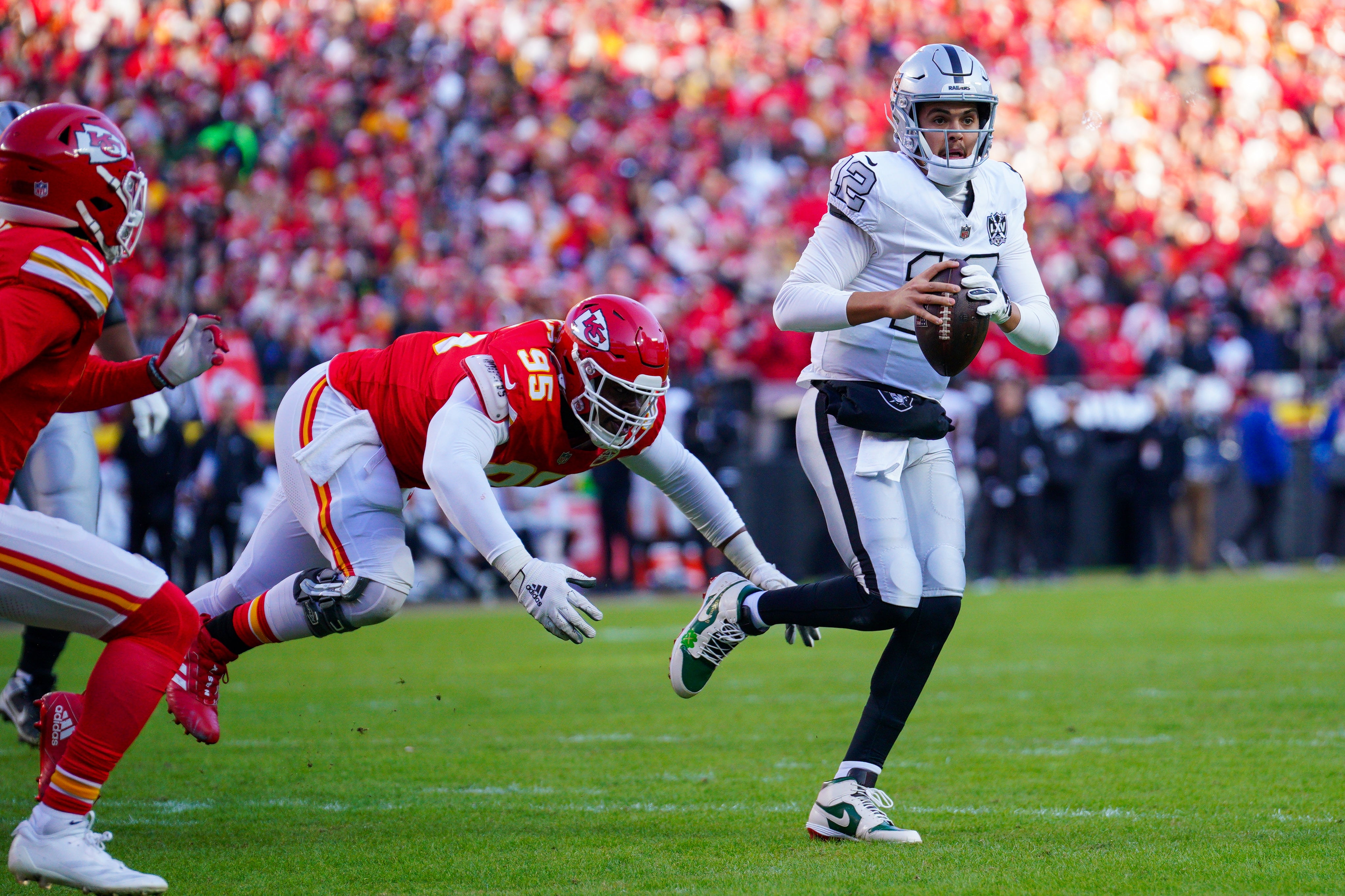 Nov 29, 2024; Kansas City, Missouri, USA; Las Vegas Raiders quarterback Aidan O'Connell (12) is sacked by Kansas City Chiefs defensive tackle Chris Jones (95) during the first half at GEHA Field at Arrowhead Stadium.