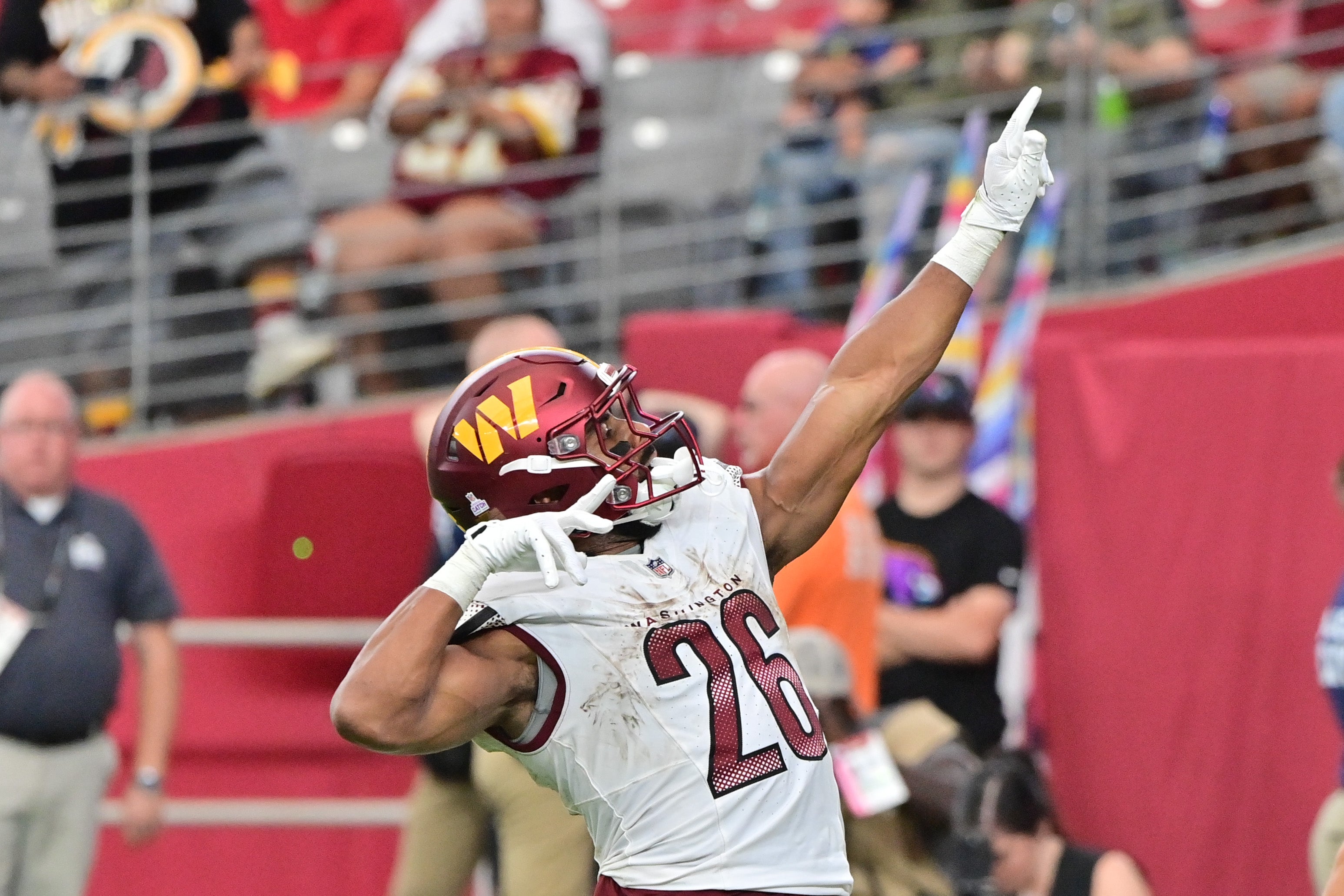 Sep 29, 2024; Glendale, Arizona, USA; Washington Commanders running back Jeremy McNichols (26) scores a touchdown in the second half against the Arizona Cardinals at State Farm Stadium. Mandatory Credit: Matt Kartozian-Imagn Images