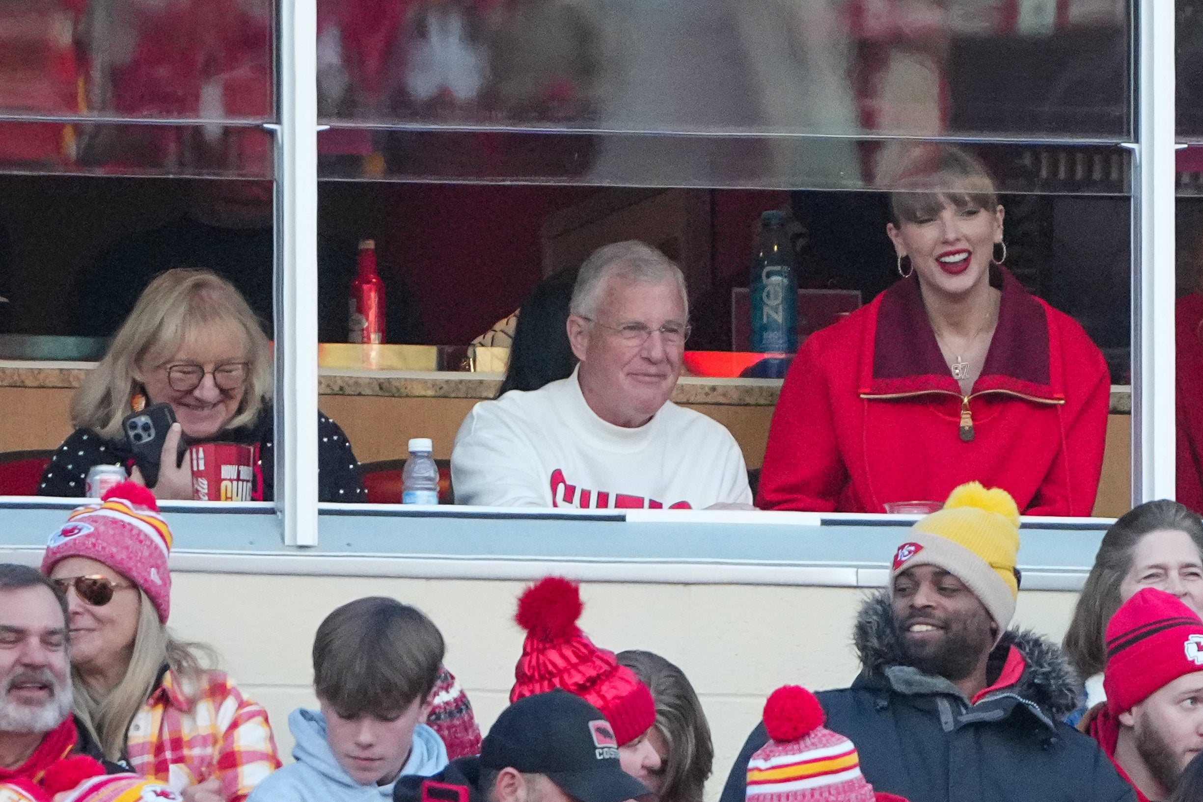 Nov 29, 2024; Kansas City, Missouri, USA; Donna Kelce and Scott Swift and pop star Taylor Swift watch play during the second half of the game between the Kansas City Chiefs and Las Vegas Raiders at GEHA Field at Arrowhead Stadium.