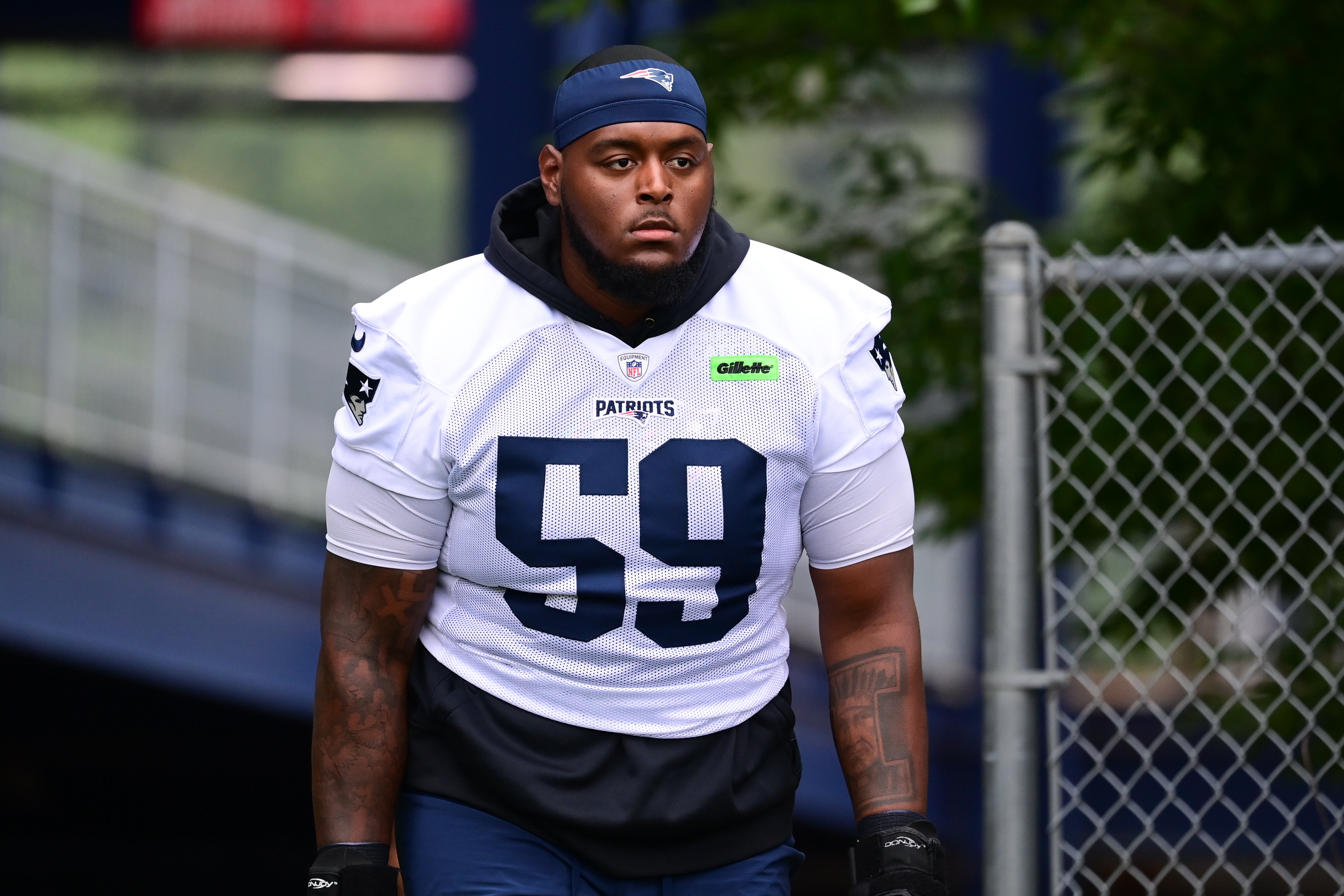 Jul 24, 2024; Foxborough, MA, USA; New England Patriots offensive tackle Vederian Lowe (59) walks to the practice field during training camp at Gillette Stadium.
