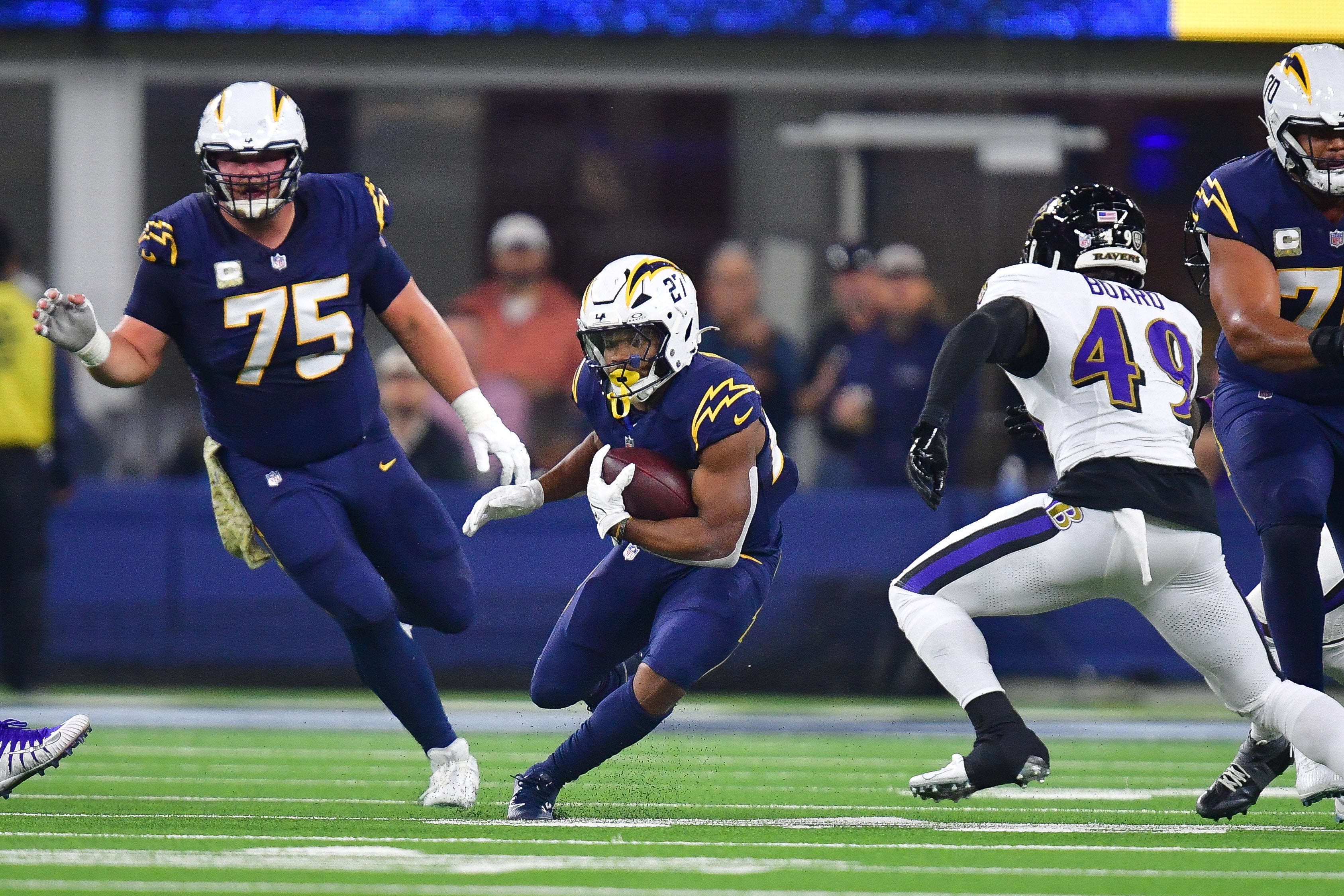 Chargers running back J.K. Dobbins (27) runs the ball against the Baltimore Ravens.