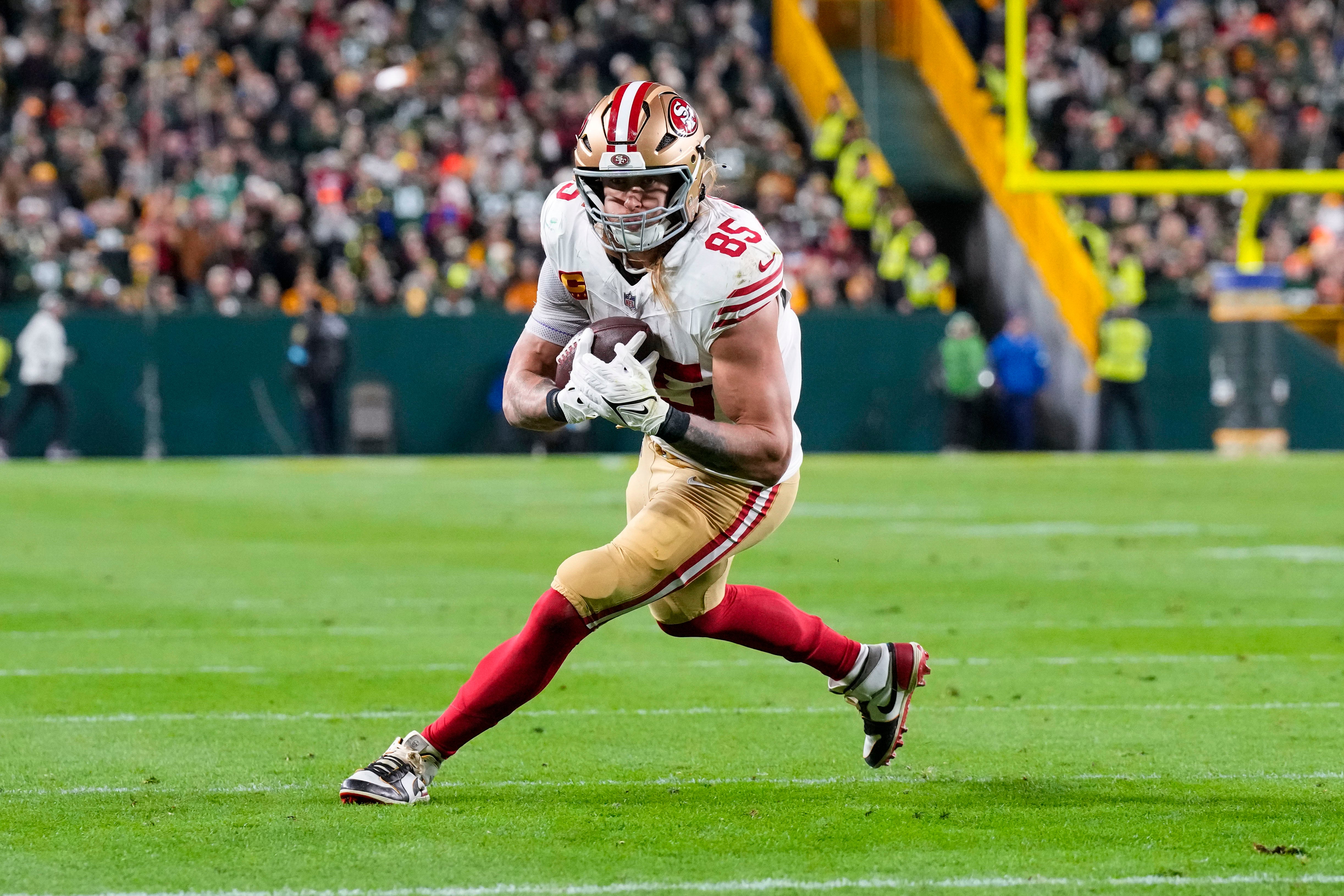 San Francisco 49ers tight end George Kittle (85) rushes with the football after catching a pass during the second quarter against the Green Bay Packers at Lambeau Field.
