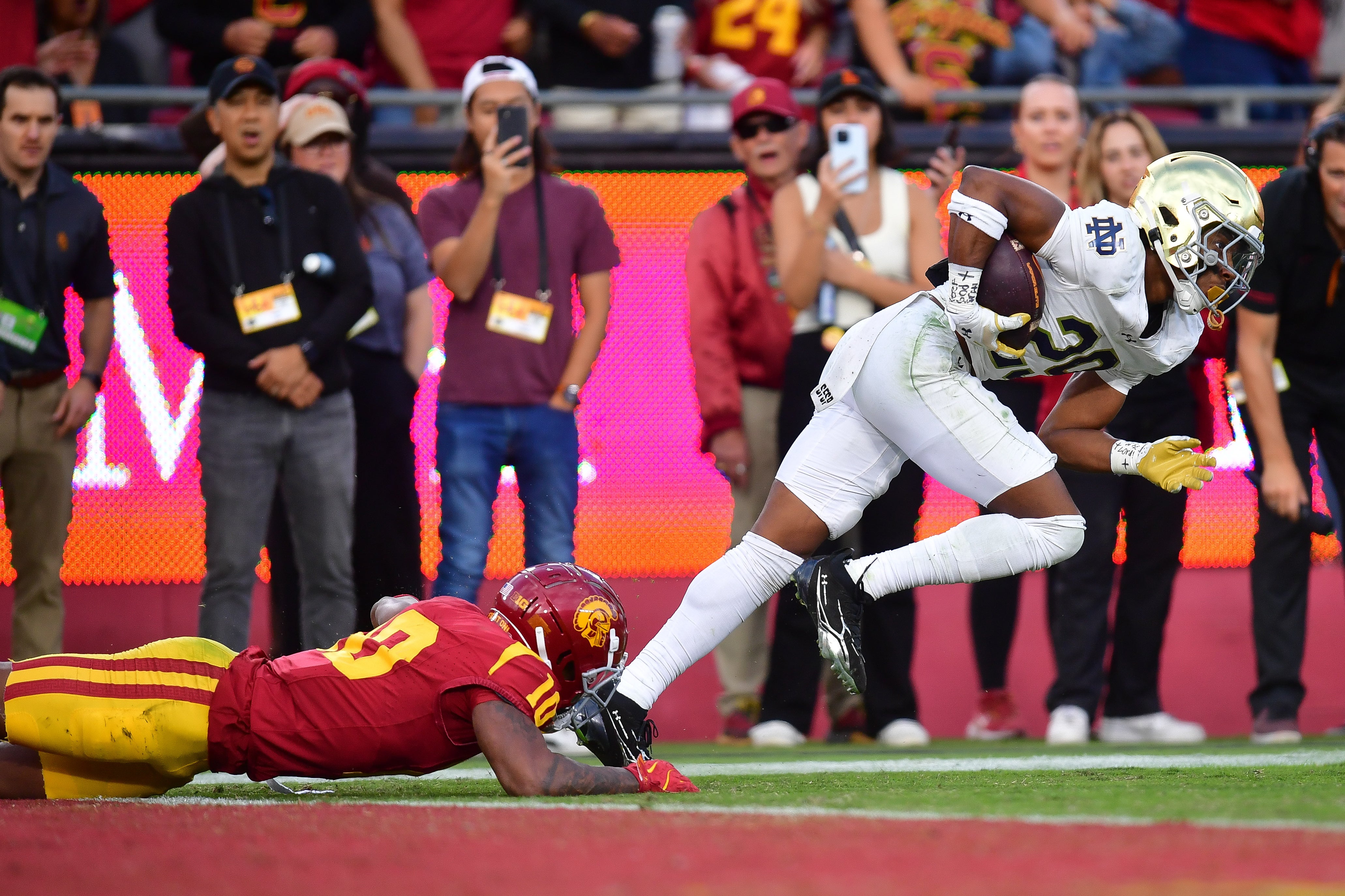 Notre Dame Fighting Irish cornerback Christian Gray (29) runs the ball after intercepting a pass intended for Southern California Trojans wide receiver Kyron Hudson (10) during the second half at the Los Angeles Memorial Coliseum.