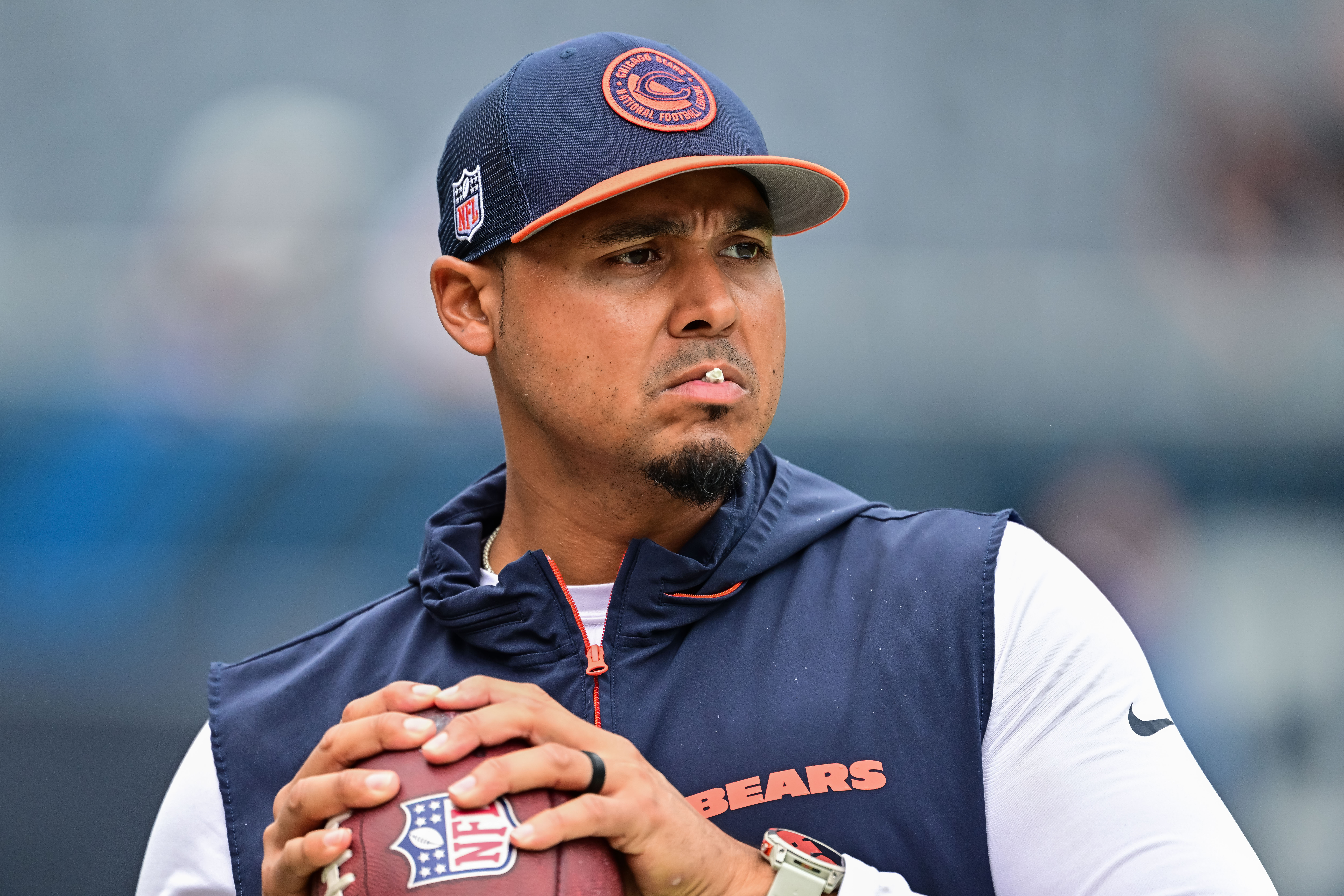 Aug 17, 2024; Chicago, Illinois, USA; Chicago Bears general manager Ryan Poles plays catch on the sideline before the game against the Cincinnati Bengals at Soldier Field.