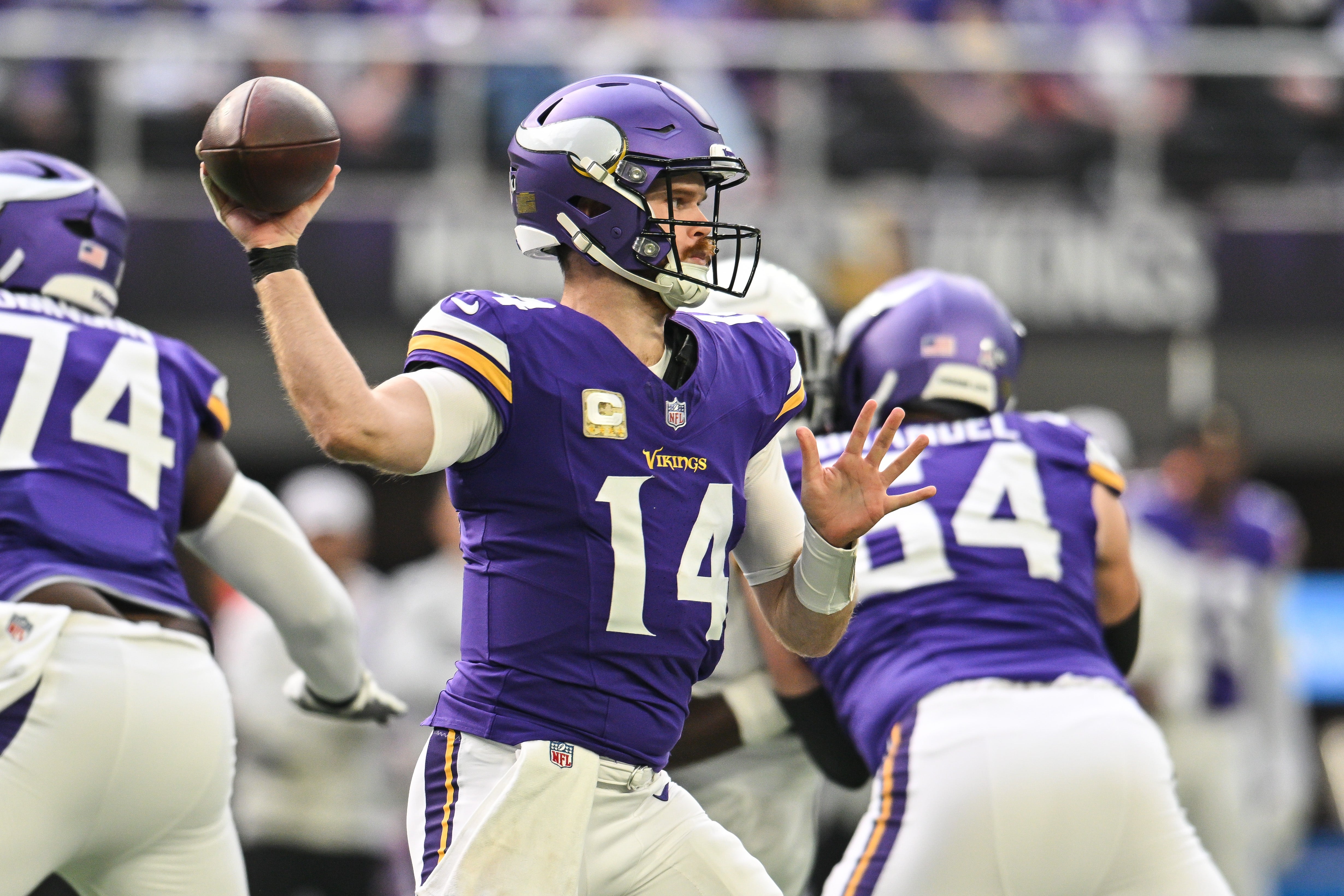 Dec 1, 2024; Minneapolis, Minnesota, USA; Minnesota Vikings quarterback Sam Darnold (14) throws a pass against the Arizona Cardinals during the first quarter at U.S. Bank Stadium.