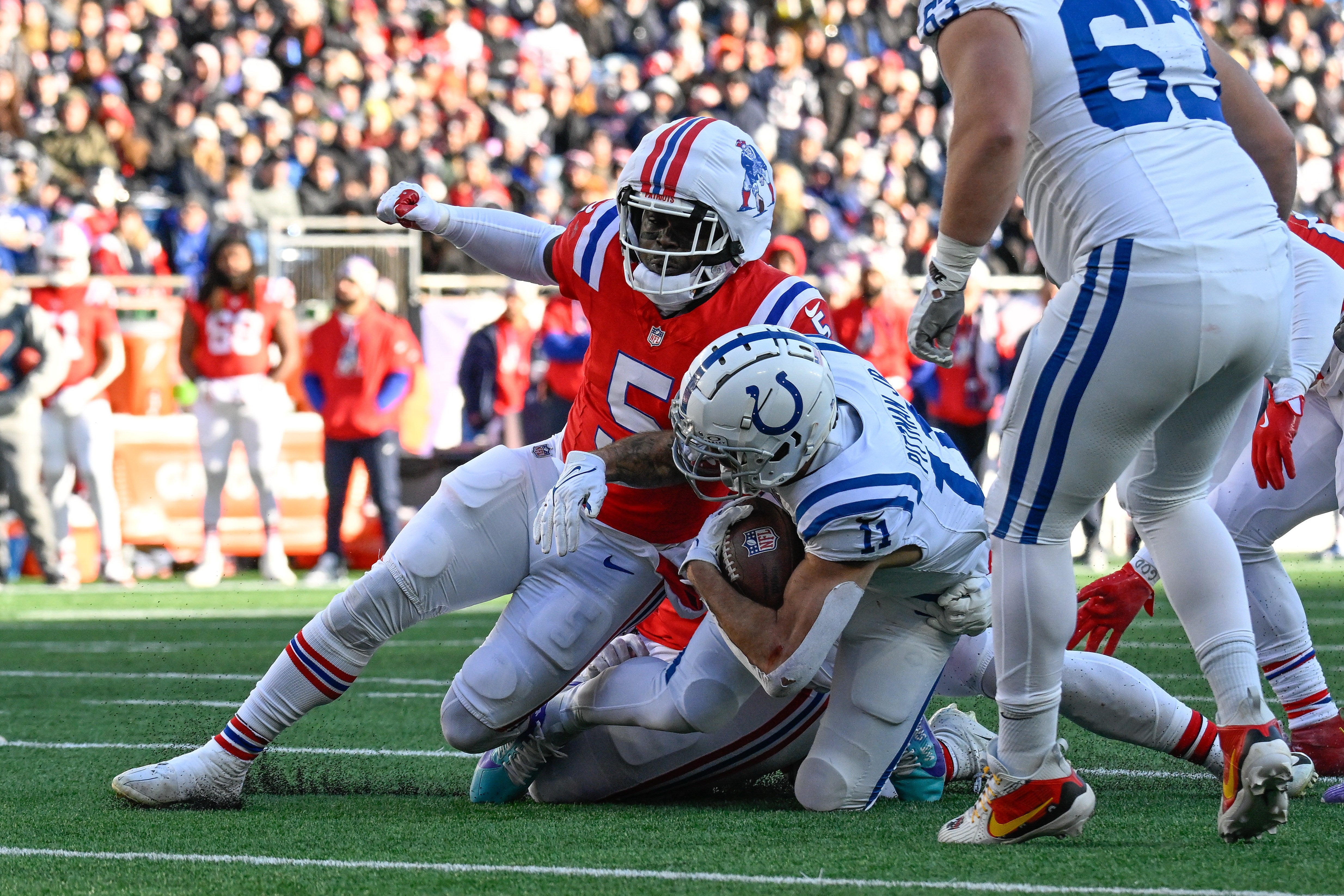 Dec 1, 2024; Foxborough, Massachusetts, USA; New England Patriots safety Jabrill Peppers (5) tackles Indianapolis Colts wide receiver Michael Pittman Jr. (11) during the first half at Gillette Stadium.
