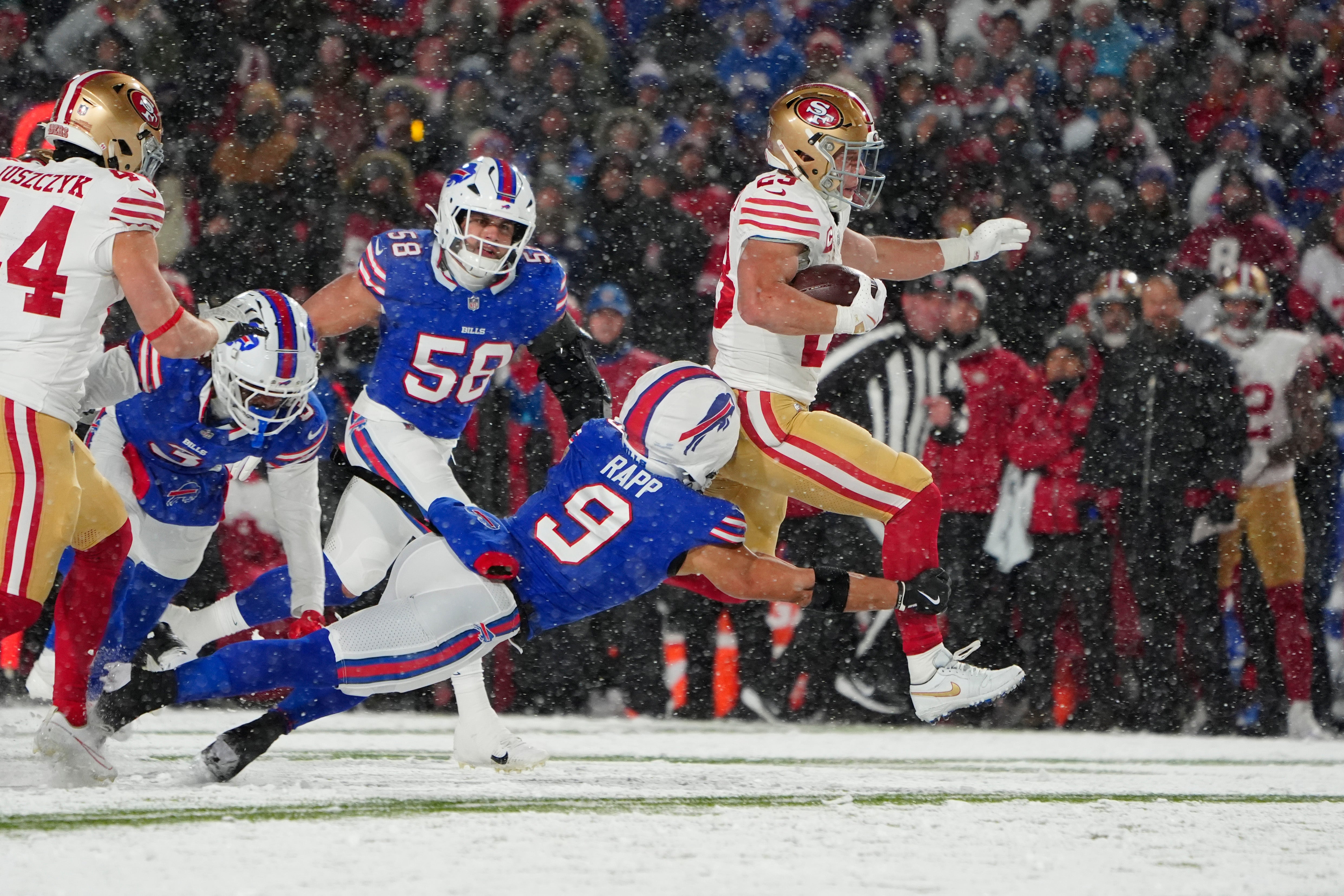 San Francisco 49ers running back Christian McCaffrey (23) runs with the ball past Buffalo Bills safety Taylor Rapp (9) during the first half at Highmark Stadium.