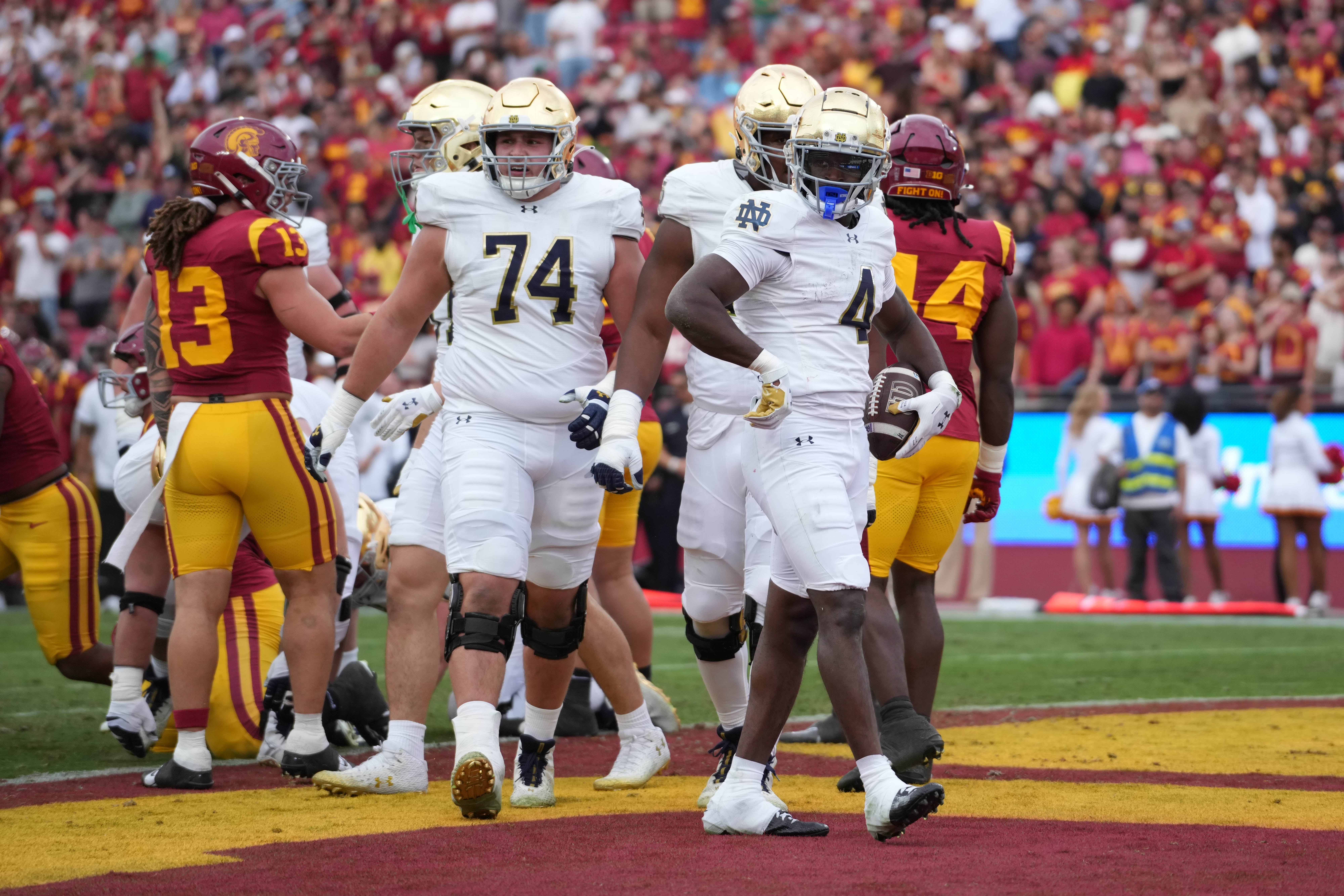 Notre Dame Fighting Irish running back Jeremiyah Love (4) celebrates after scoring on a 1-yard touchdown run against the Southern California Trojans in the first half at United Airlines Field at Los Angeles Memorial Coliseum.