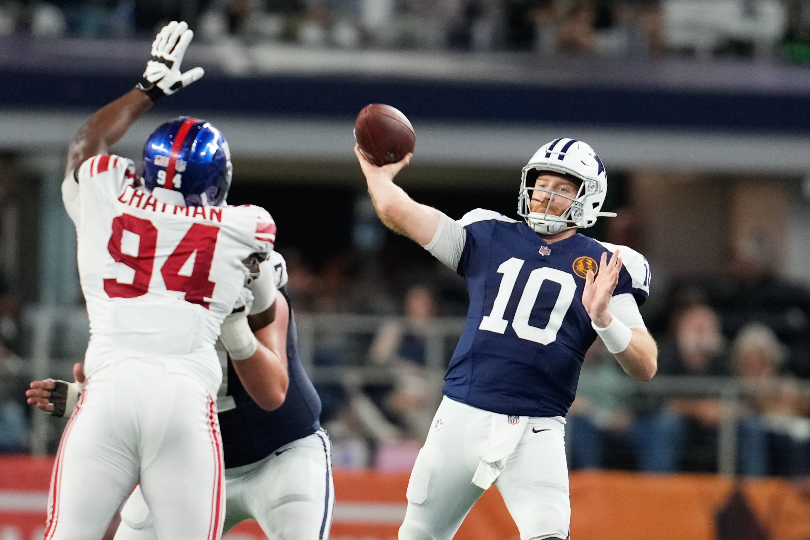 Dallas Cowboys quarterback Cooper Rush (10) throws a pass as New York Giants defensive tackle Elijah Chatman (94) defends during the second half at AT&T Stadium.