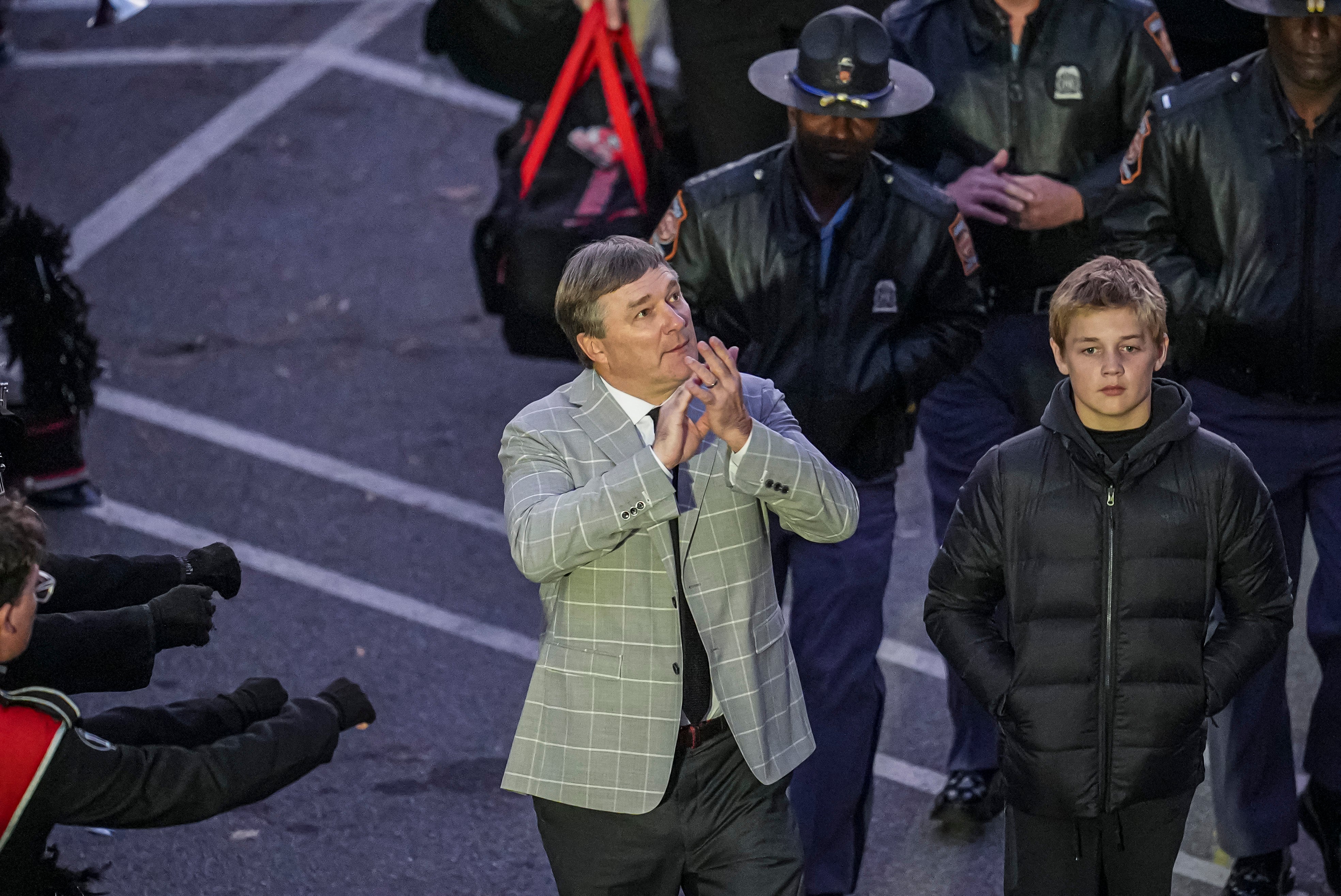Georgia Bulldogs head coach Kirby Smart reacts as he walks in the dawg walk with his son Andrew prior to the game against the Georgia Tech Yellow Jackets at Sanford Stadium.