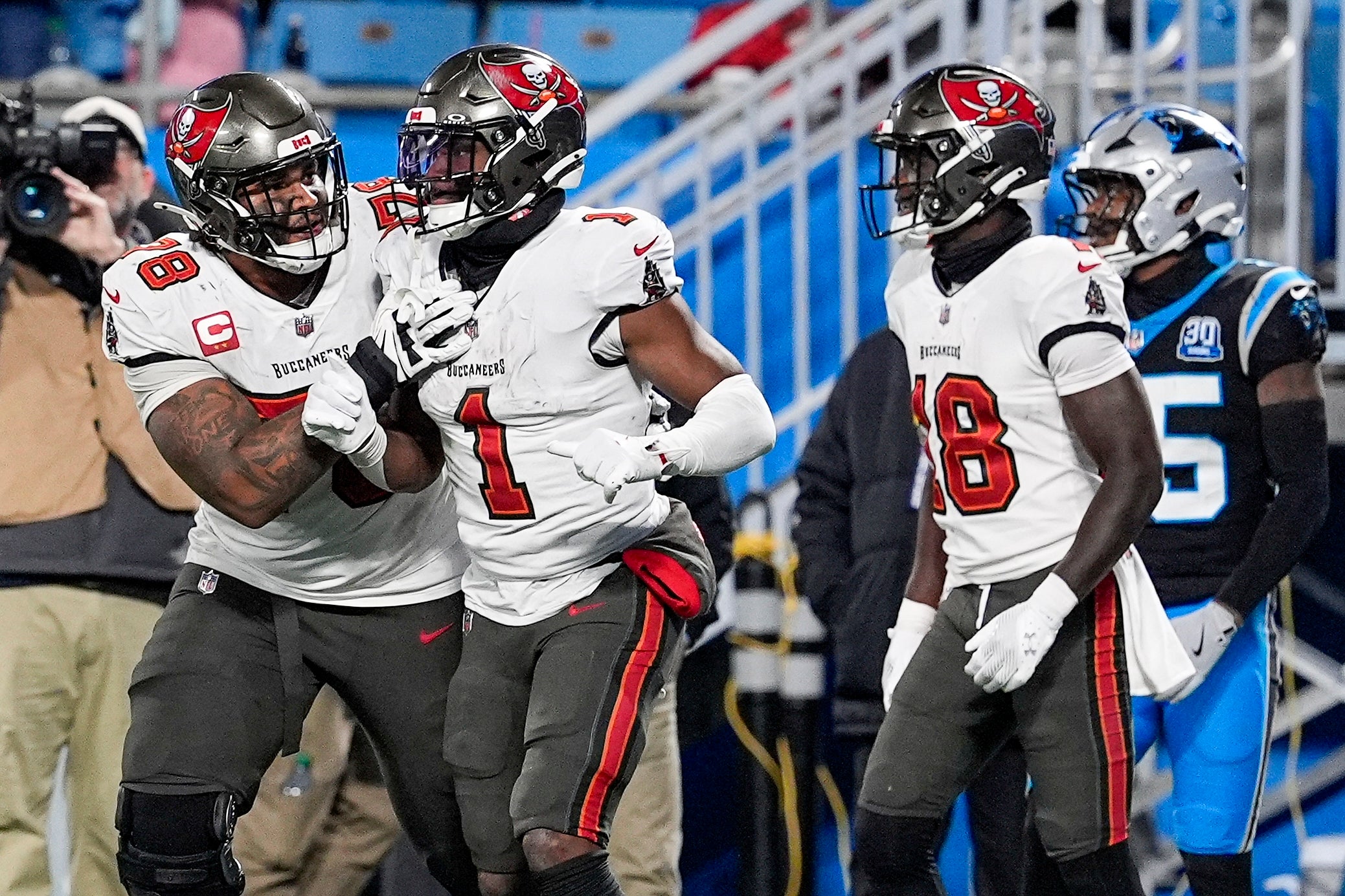 Dec 1, 2024; Charlotte, North Carolina, USA; Tampa Bay Buccaneers offensive tackle Tristan Wirfs (78) celebrates a score by running back Rachaad White (1) during the second half against the Carolina Panthers at Bank of America Stadium