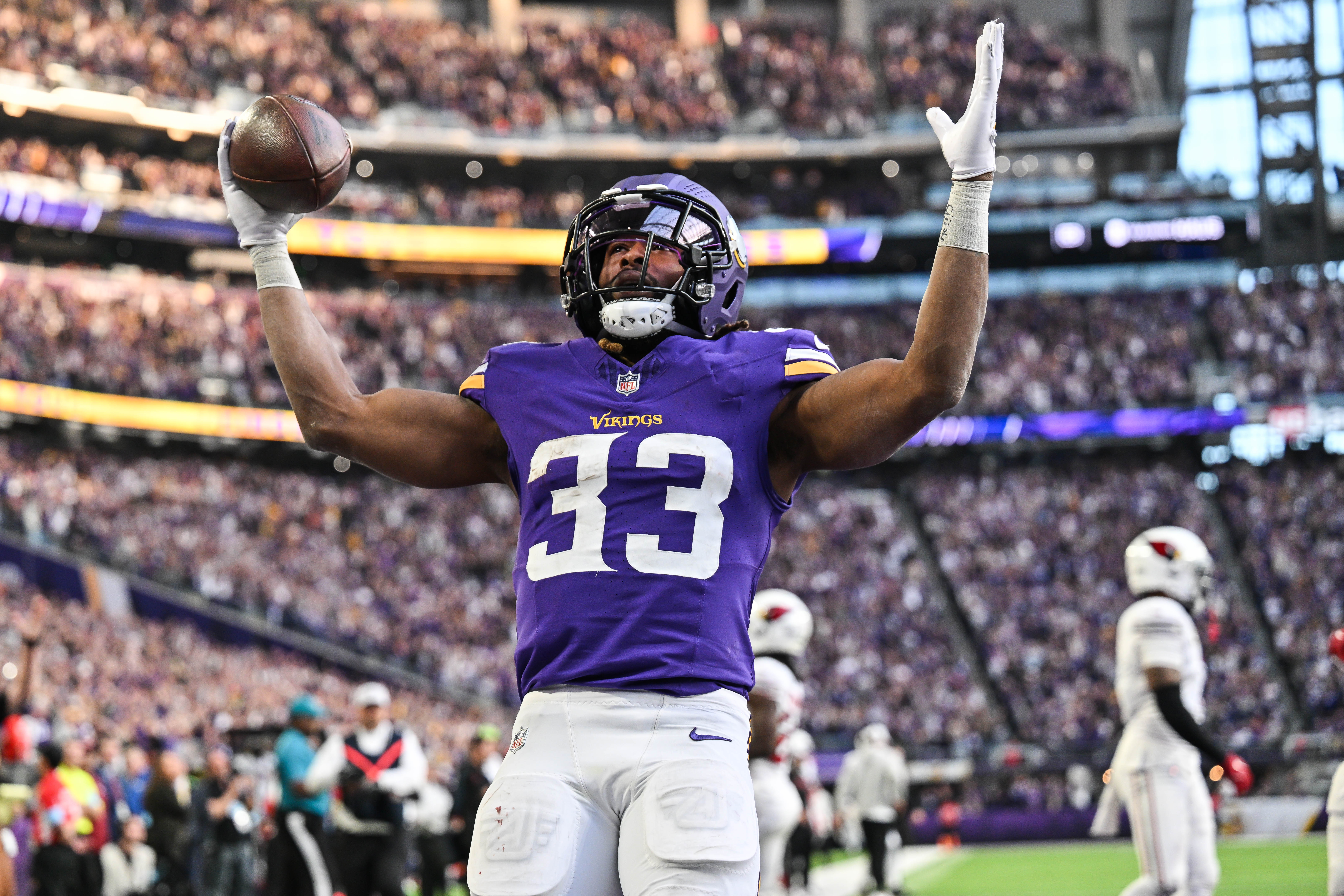Dec 1, 2024; Minneapolis, Minnesota, USA; Minnesota Vikings running back Aaron Jones (33) reacts after scoring the game winning touchdown against the Arizona Cardinals during the fourth quarter at U.S. Bank Stadium.