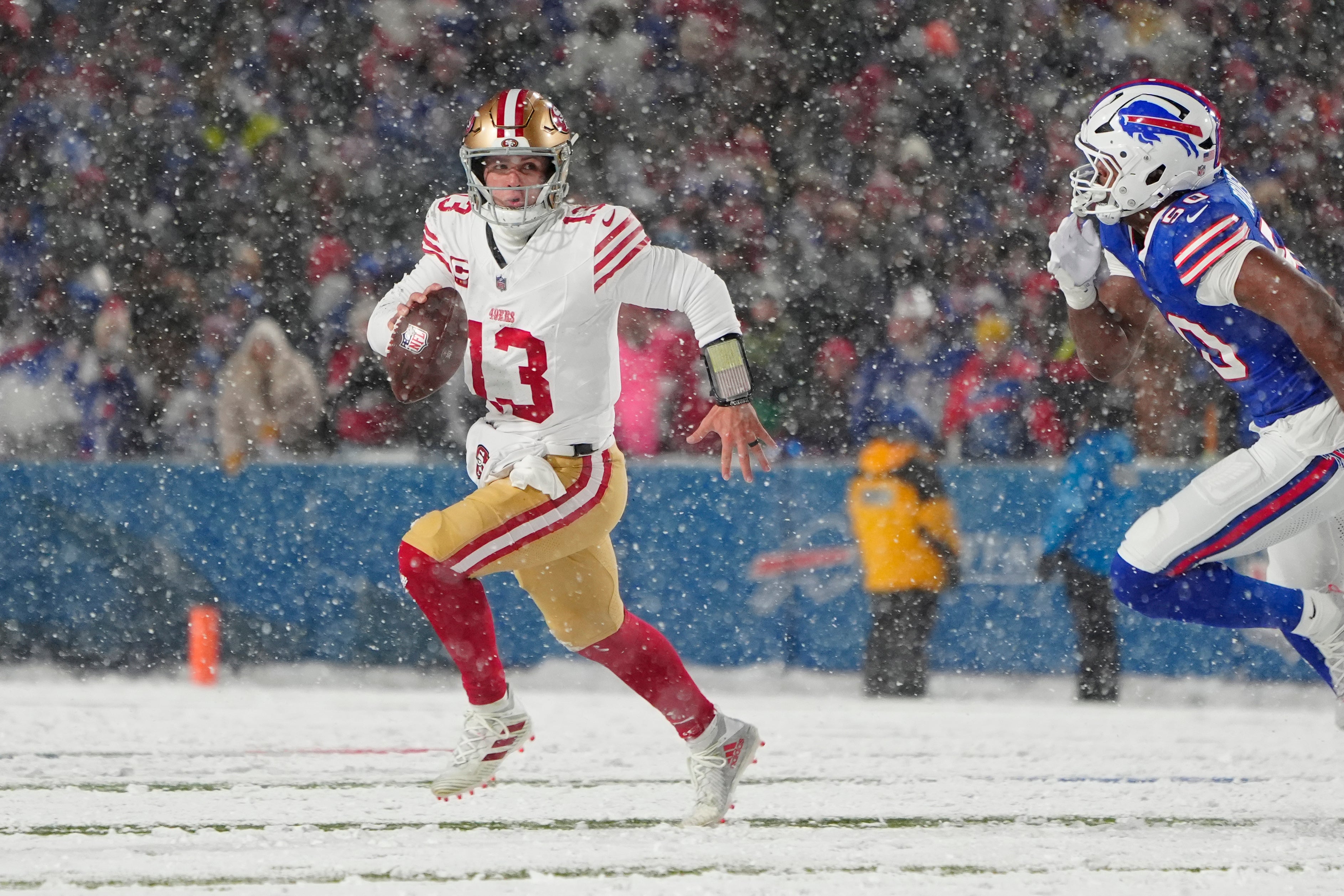 San Francisco 49ers quarterback Brock Purdy (13) runs with the ball against the Buffalo Bills during the first half at Highmark Stadium.