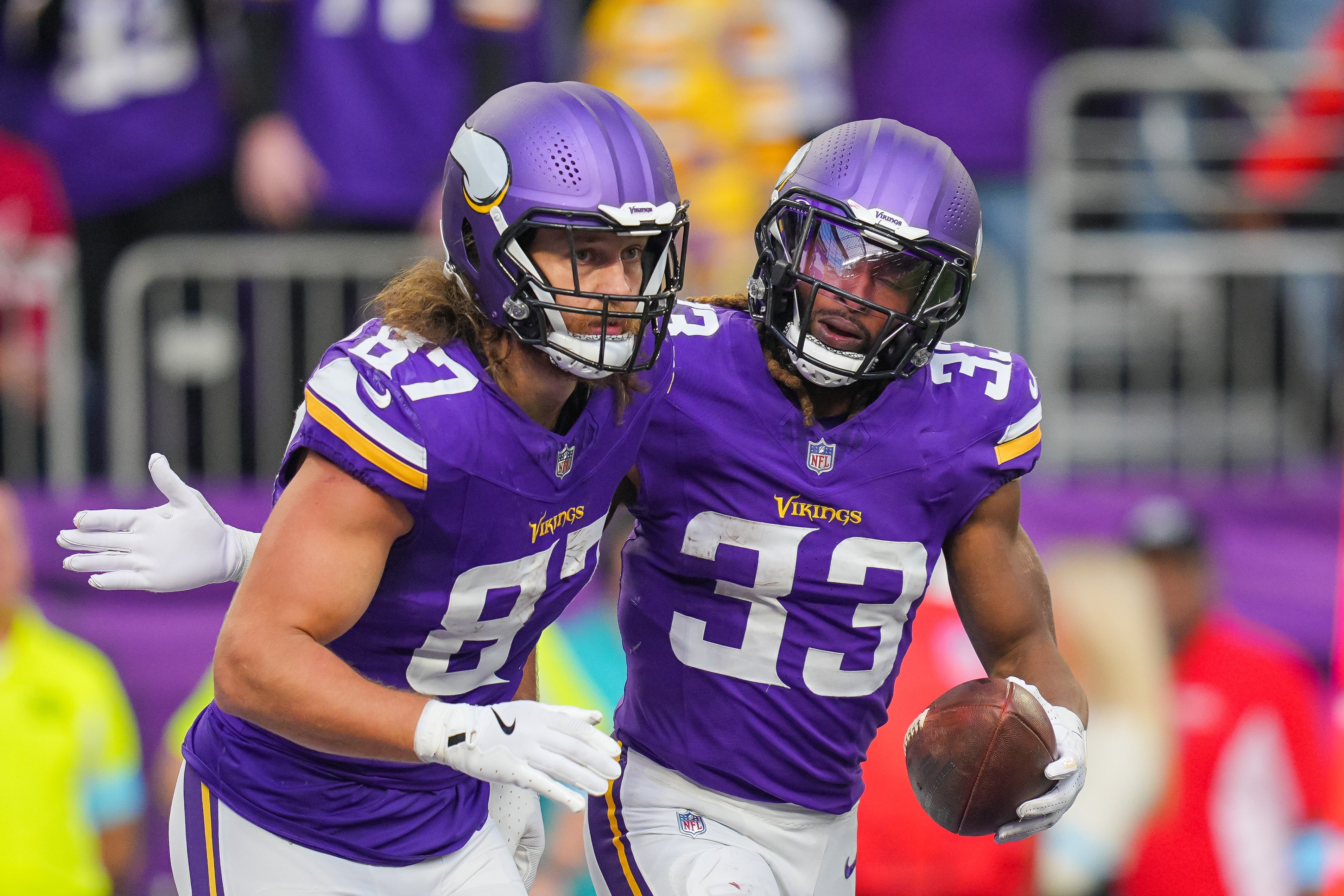 Dec 1, 2024; Minneapolis, Minnesota, USA; Minnesota Vikings running back Aaron Jones (33) celebrates his touchdown with tight end T.J. Hockenson (87) against the Arizona Cardinals in the fourth quarter at U.S. Bank Stadium.