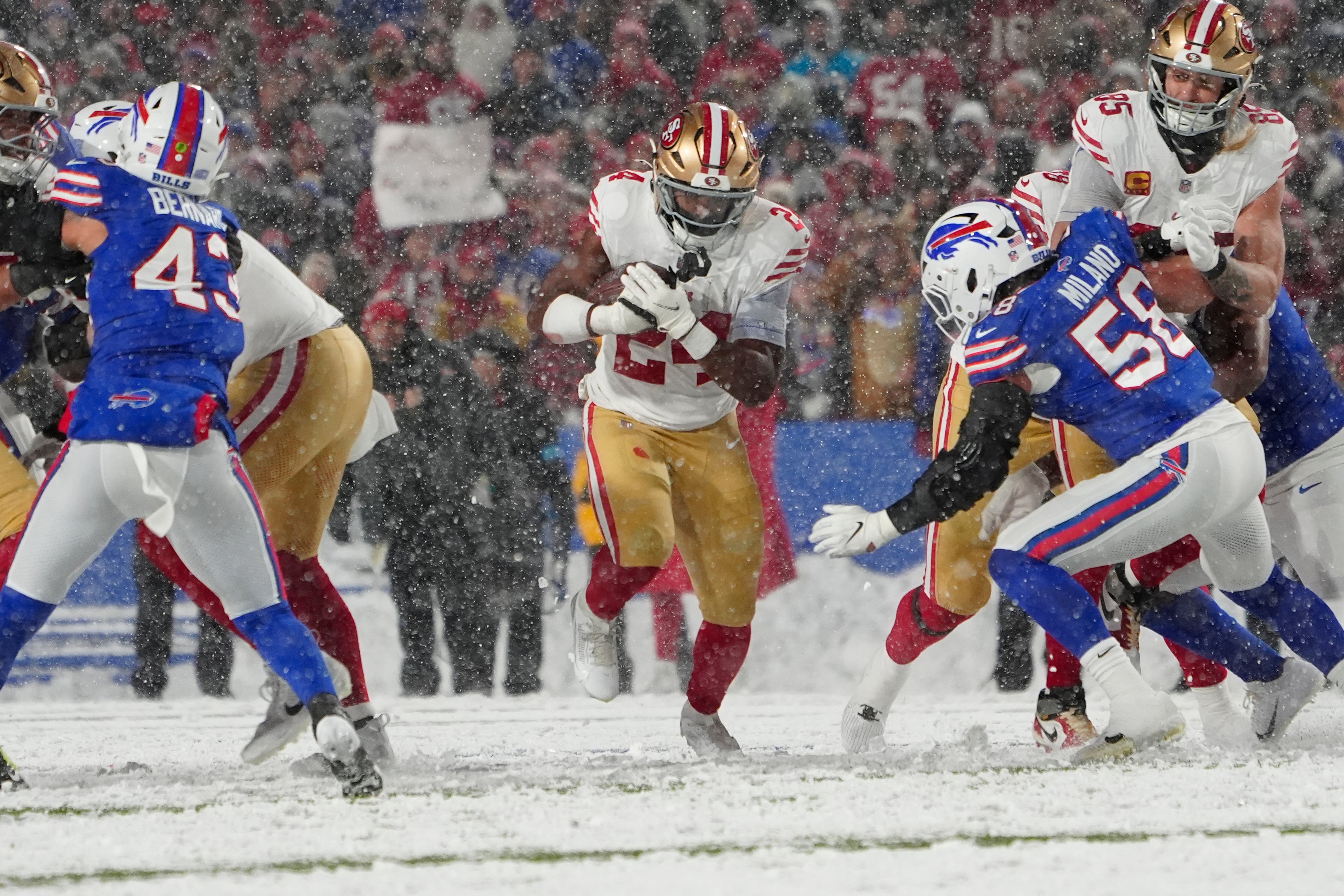 San Francisco 49ers running back Jordan Mason (24) runs with the ball against the Buffalo Bills during the first half at Highmark Stadium.