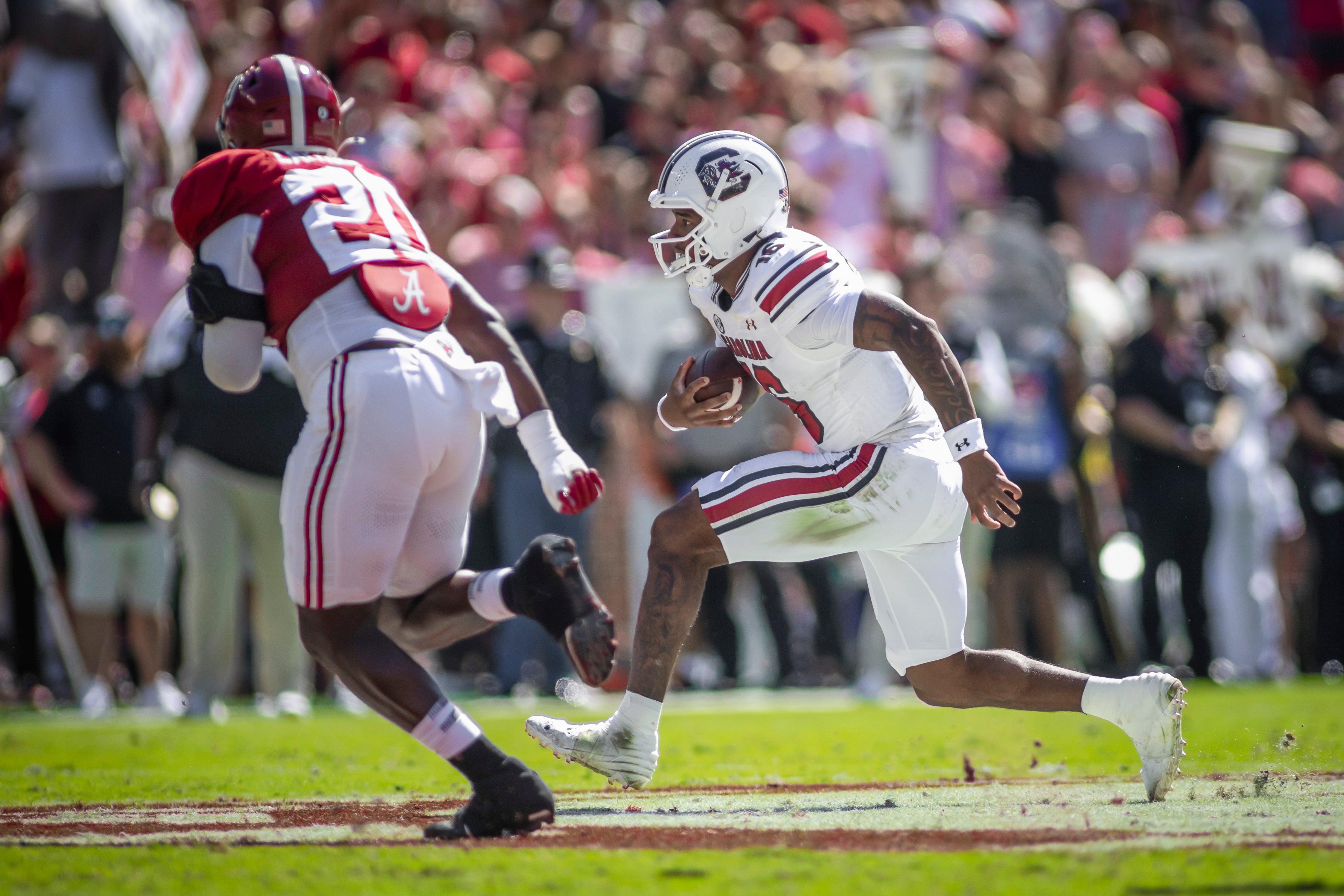 South Carolina Gamecocks quarterback LaNorris Sellers (16) runs the ball against Alabama Crimson Tide defensive lineman Jah-Marien Latham (20) during the second quarter at Bryant-Denny Stadium.