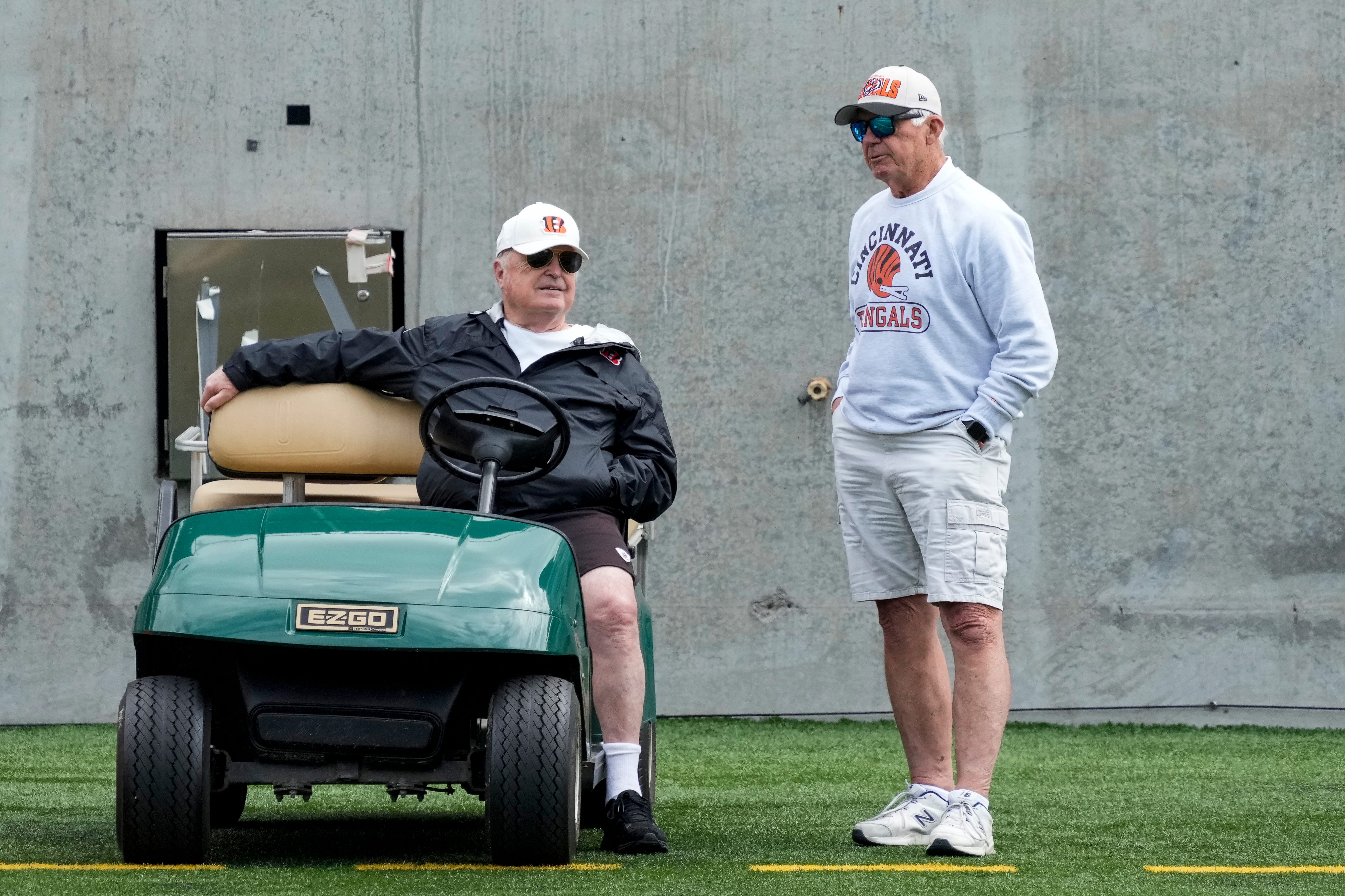 Cincinnati Bengals owner Mike Brown talks with former quarterback Ken Anderson during an off-season workout inside Paycor Stadium in downtown Cincinnati on Tuesday, June 13, 2023.