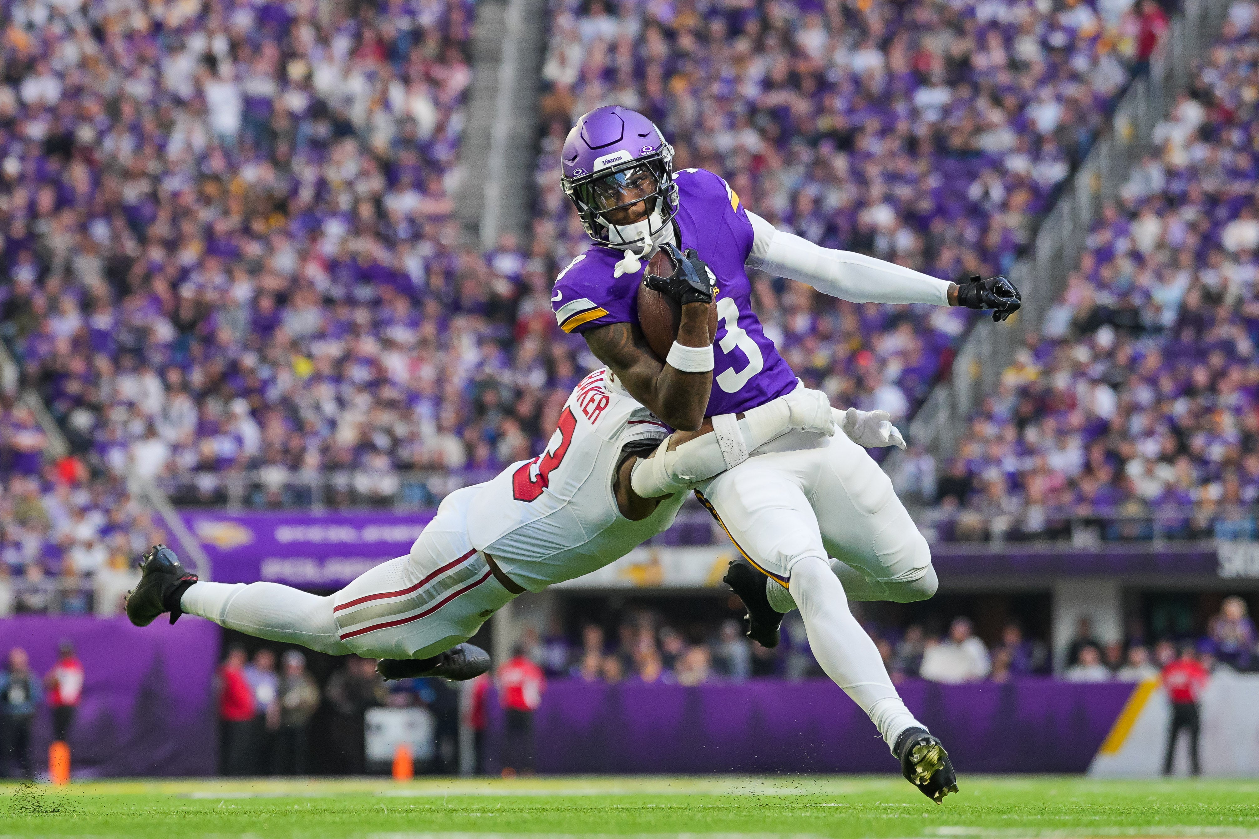 Dec 1, 2024; Minneapolis, Minnesota, USA; Minnesota Vikings wide receiver Jordan Addison (3) runs after the catch against the Arizona Cardinals safety Budda Baker (3) in the fourth quarter at U.S. Bank Stadium.